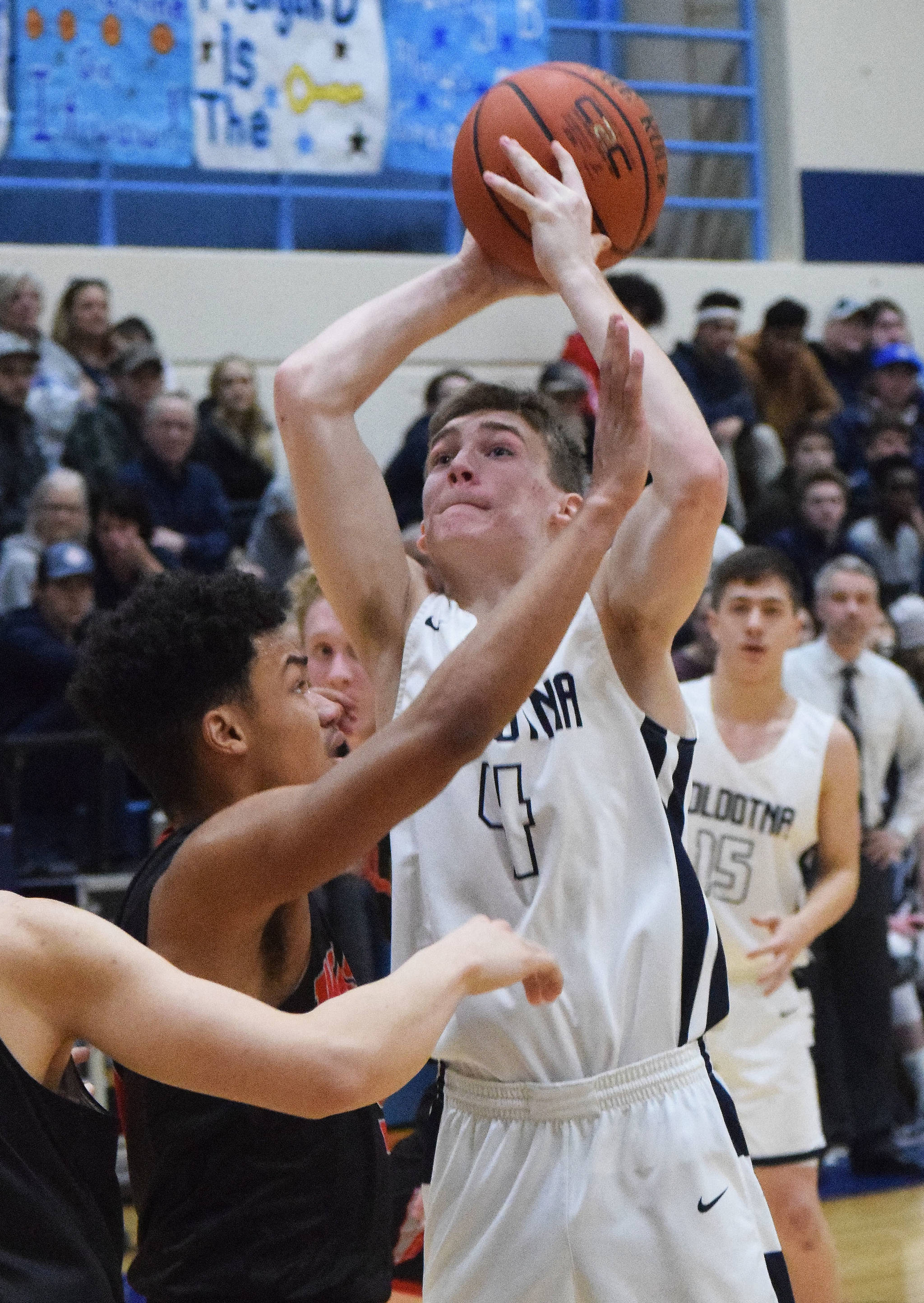 Soldotna’s Tyler Morrison (4) puts up a shot against Wasilla’s Daniel Headdings Friday night in a conference meeting at Soldotna High School. (Photo by Joey Klecka/Peninsula Clarion)