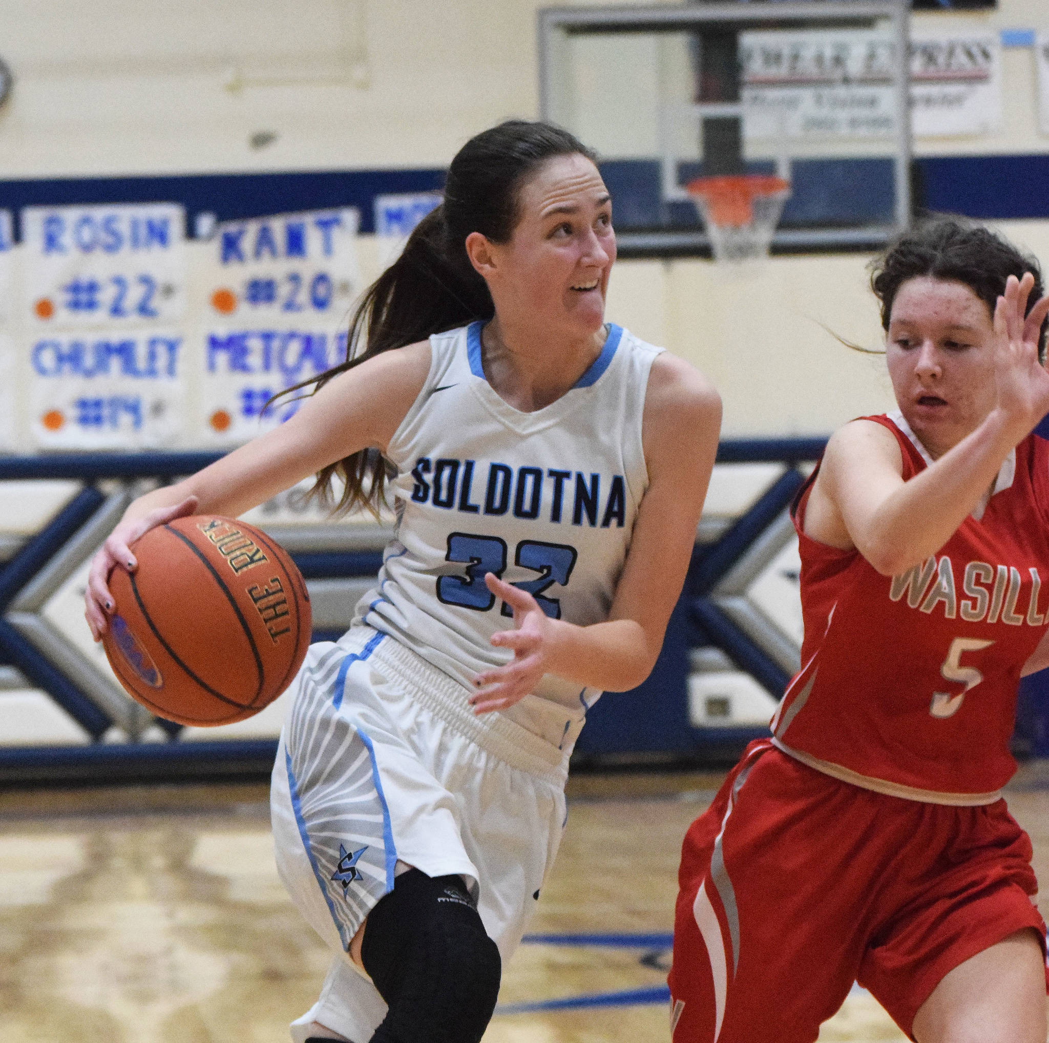 Soldotna’s Danica Schmidt drives against Wasilla’s Harmony McSorley (right) Friday night in a conference meeting at Soldotna High School. (Photo by Joey Klecka/Peninsula Clarion)