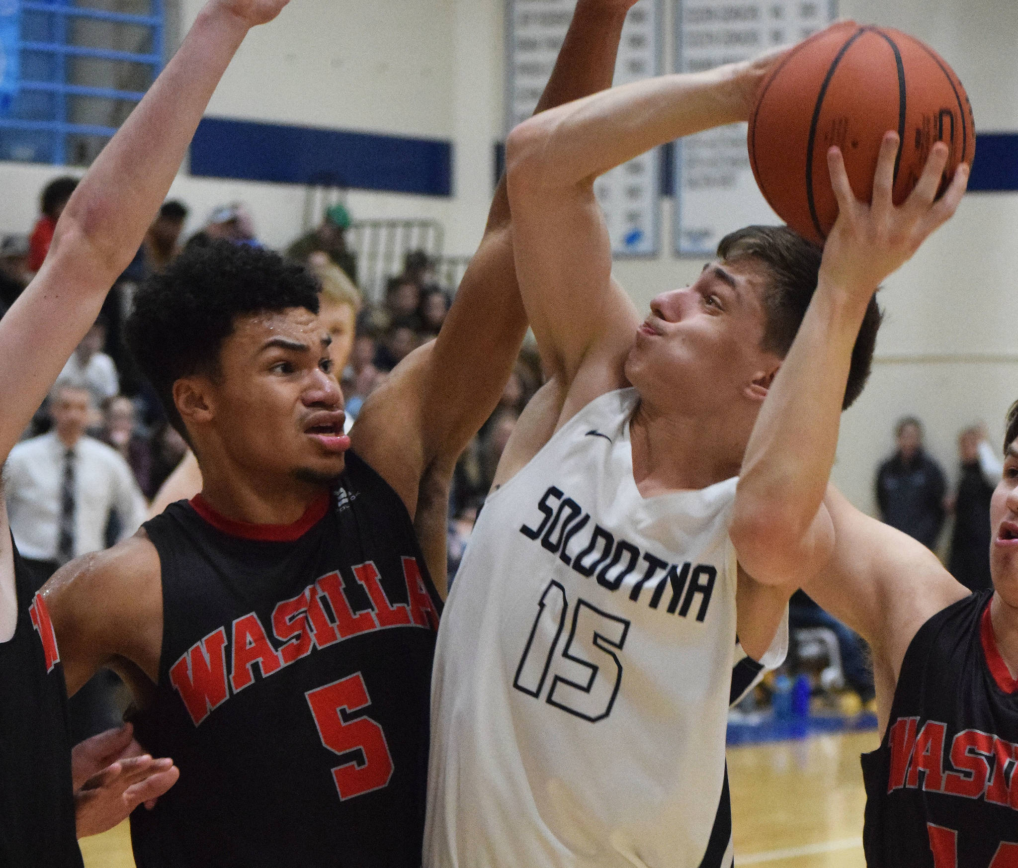 Soldotna’s Jersey Truesdell (15) attempts a shot against Wasilla’s Daniel Headdings Friday night in a conference meeting at Soldotna High School. (Photo by Joey Klecka/Peninsula Clarion)