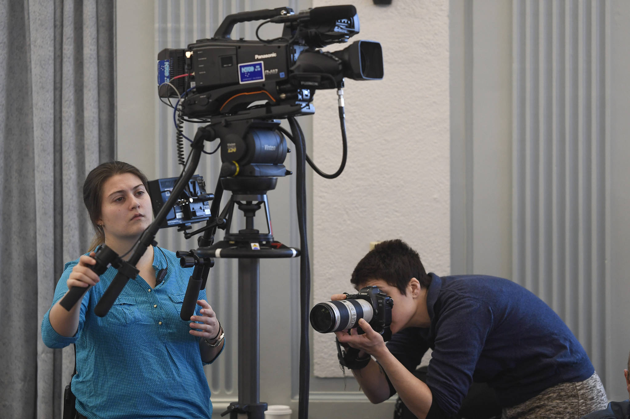 Bethany Lowrance, left, of Gavel Alaska, and Rashah McChesney, a reporter with the Alaska Energy Desk (a collaboration between stations of the Alaska Public Radio Network), cover a Senate Finance Committee meeting at the Capitol on Thursday, Feb. 14, 2019. Gov. Mike Dunleavy’s budget may end all state funding for public radio and broadcast stations. (Michael Penn | Juneau Empire)