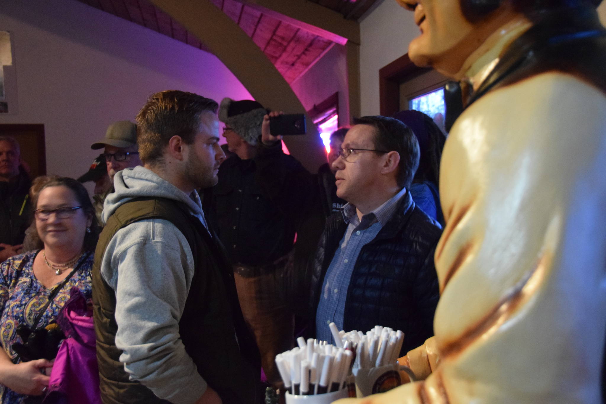 An aide, left, of Rep. Gary Knopp, R- Soldotna and a representative from Alaska Right to Life, right, confront each other during a town hall at the Kenai River Suites in Soldotna on Feb. 15, 2019. (Photo by Brian Mazurek/Peninsula Clarion)