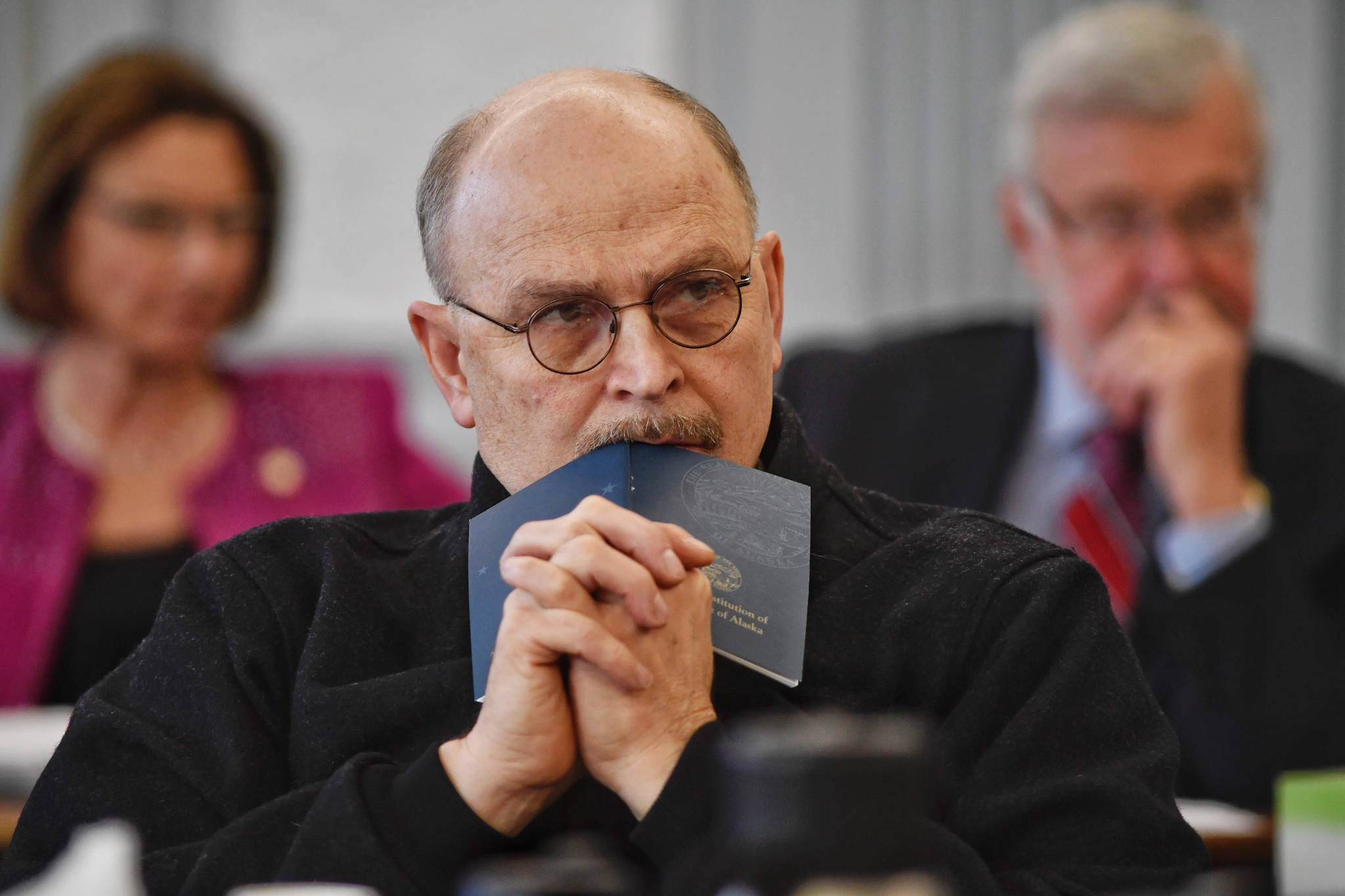 Sen. Click Bishop, R-Fairbanks, rests his head on a Constitution of Alaska booklet as he listens to Donna Arduin, Director of the Office of Management and Budget, and Mike Barnhill, policy director for the OMB, continue to present Gov. Mike Dunleavy’s budget to the Senate Finance Committee at the Capitol on Tuesday, Feb. 19, 2019. Senate President Cathy Giessel, R - Anchorage, left, and Sen. Gary Stevens, R-Kodiak, right, are in the background. (Michael Penn | Juneau Empire)