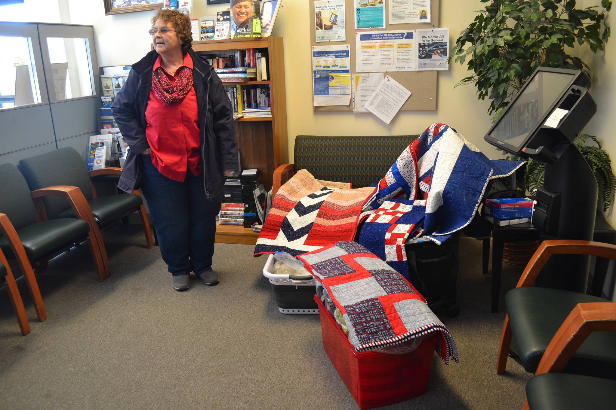 Kalie Klaysmat, President and co-founder of Quilts for Heroes, delivers over a dozen quilts to peninsula veterans undergoing chemotherapy on Thursday, Feb. 21, 2019, in Kenai, Alaska. (Photo by Victoria Petersen/Peninsula Clarion)