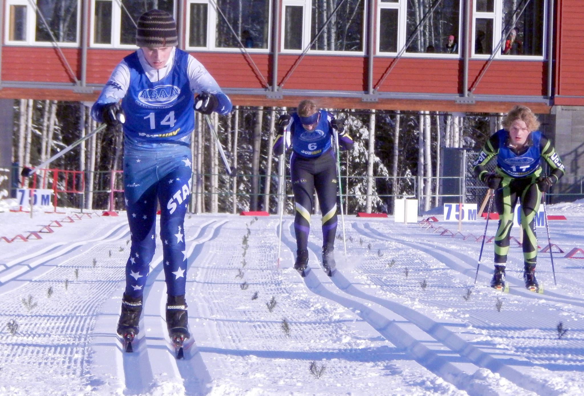 Soldotna’s Lance Chilton approaches the finish line while Lathrop’s Harrison Riggs, center, and Colony’s Norse Iverson, right, follow during the boys 7.5-kilometer classic technique race of the state ski meet Thursday at the Birch Hill Recreation Area in Fairbanks. (Photo by Danny Martin/Fairbanks Daily News-Miner)