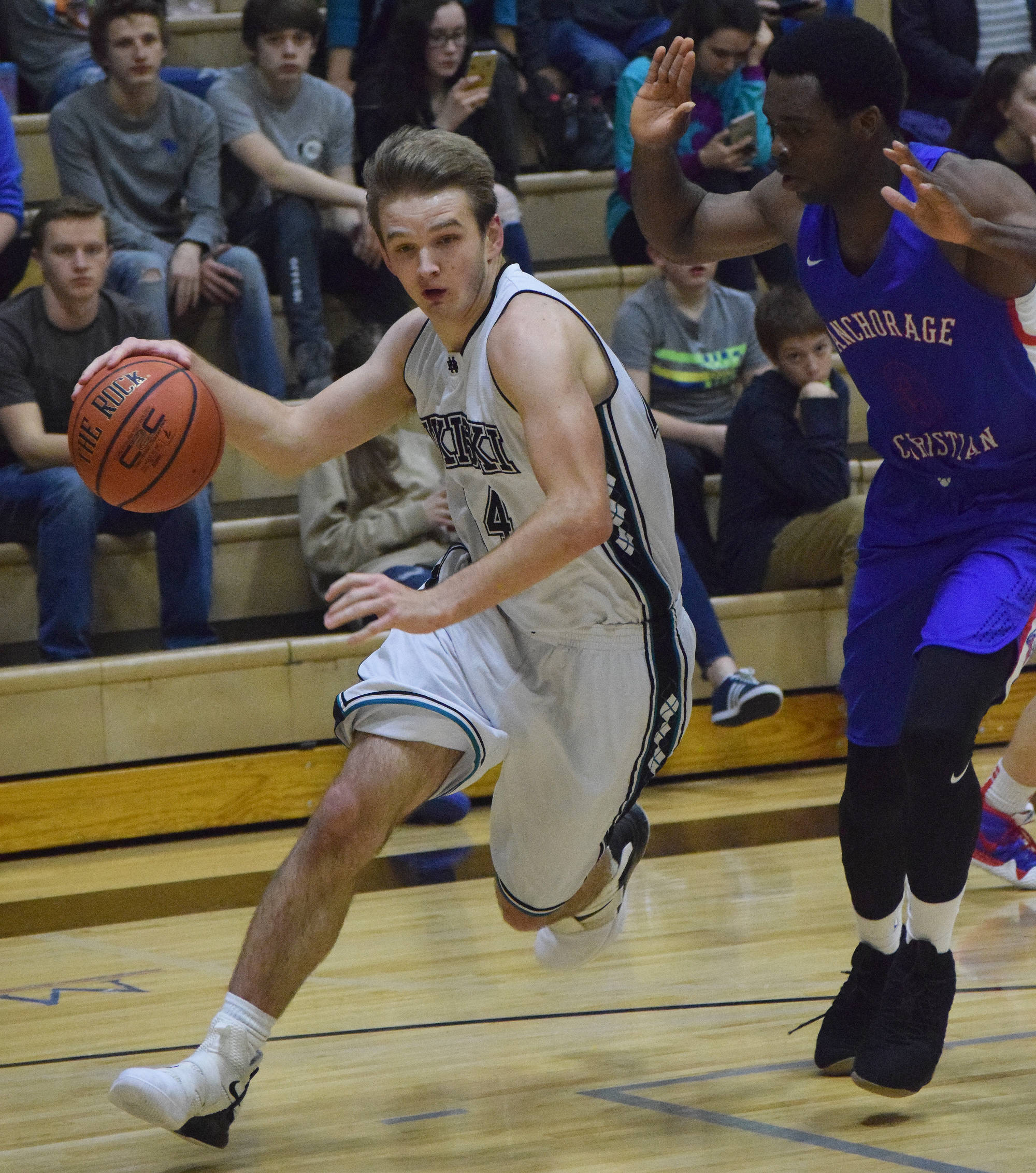 Nikiski’s Michael Eiter (left) dribbles against Anchorage’s Frederick Onochie Friday in a Southcentral Conference contest at Nikiski High School. (Photo by Joey Klecka/Peninsula Clarion)