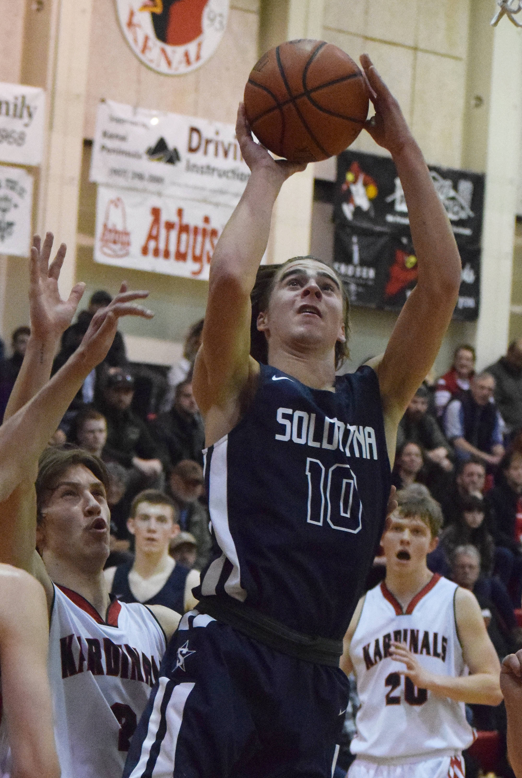 Soldotna’s Zach Hanson (10) takes a shot Saturday against Kenai Central in a nonconference clash at Kenai Central High School. (Photo by Joey Klecka/Peninsula Clarion)