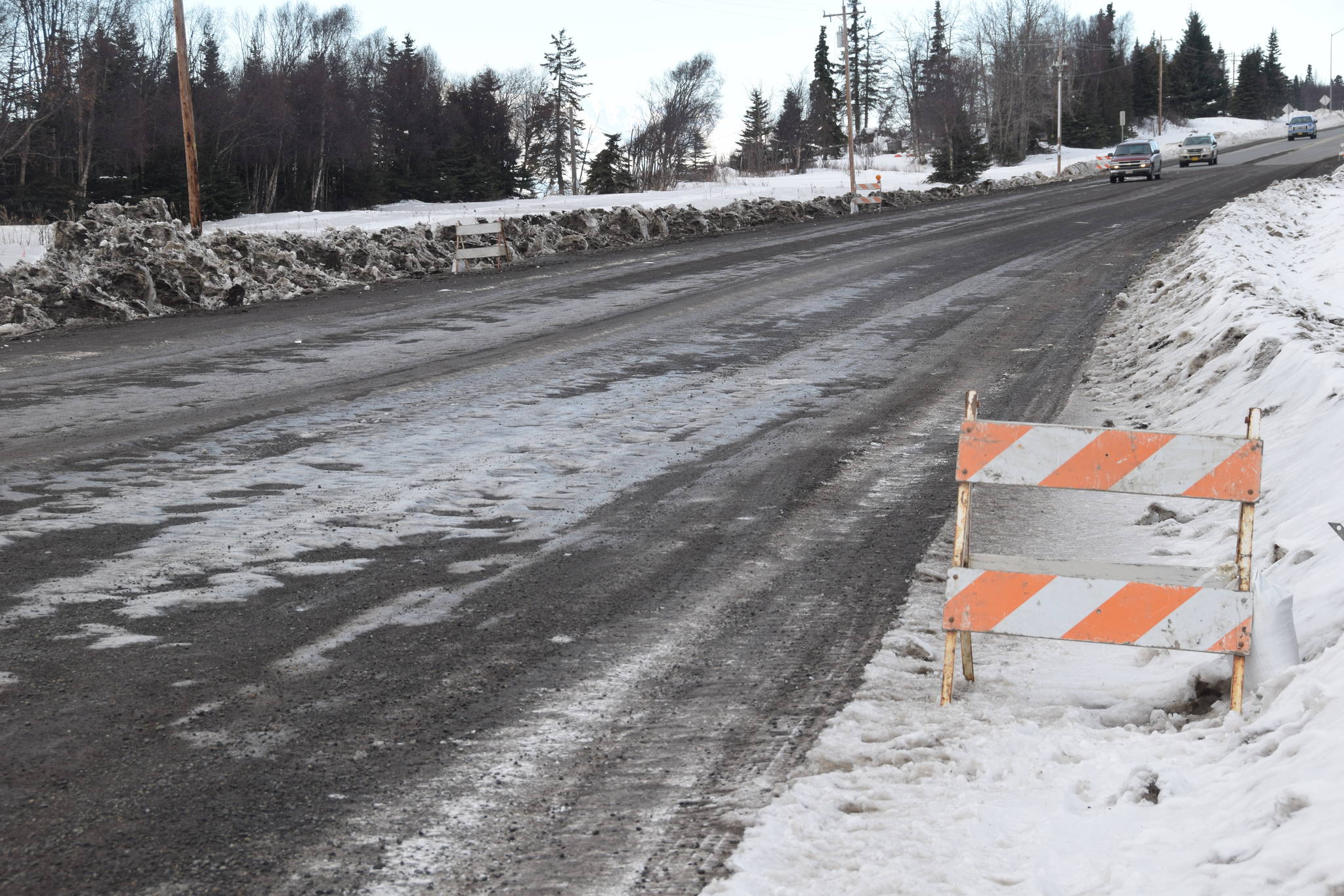 The section of unpaved road on the Kenai Spur Highway heading into Nikiski, as seen on Feb. 26, 2019. (Photo by Brian Mazurek/Peninsula Clarion)