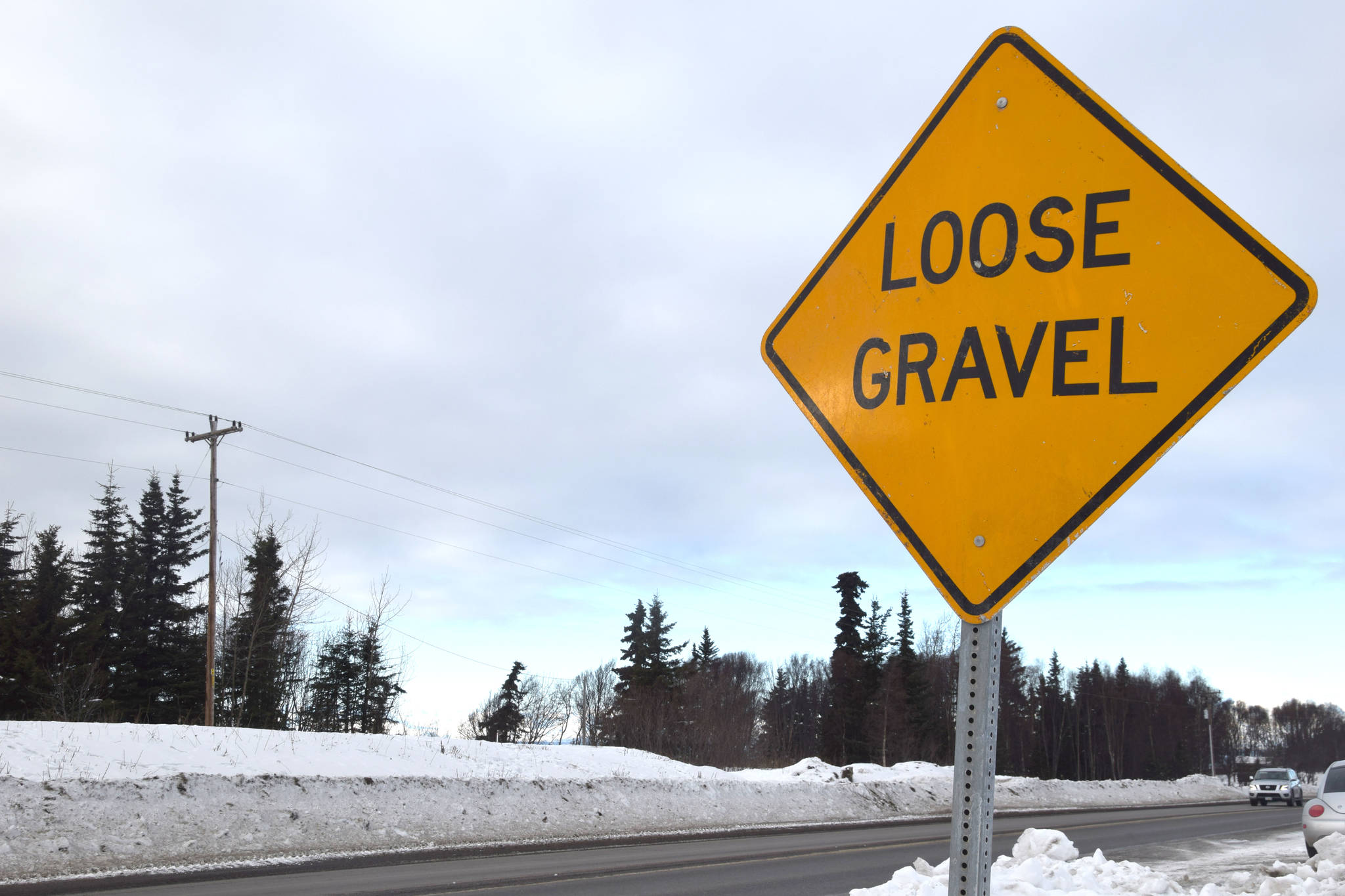 A sign along the Kenai Spur Highway warns drivers of damage ahead, as seen on Feb. 26, 2019. (Photo by Brian Mazurek/Peninsula Clarion)