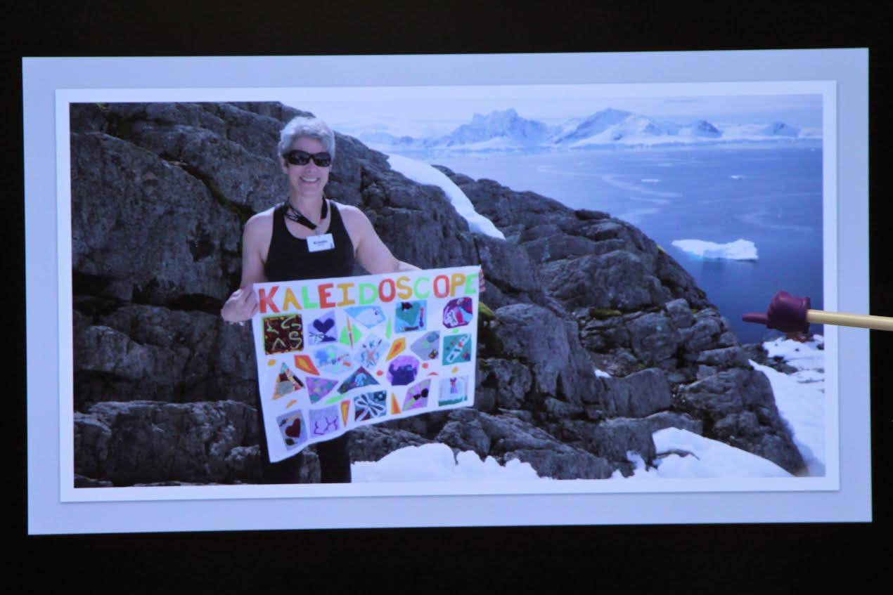 Dr. Kristin Mitchell holding the Kaleidoscope School of Arts and Sciences flag while visiting Antarctica. (Photos courtesy of Debbie Boyle/Kaleidoscope School of Arts and Sciences)