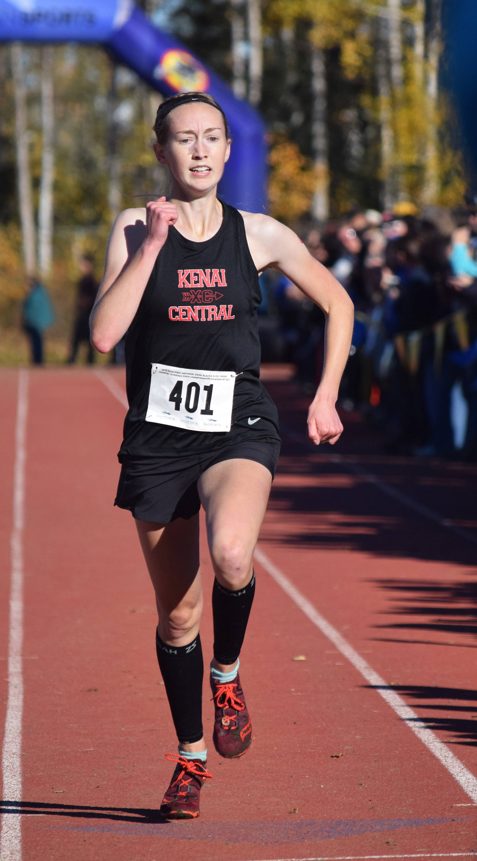 Kenai Central senior Jaycie Calvert sprints to the finish line to win the Division II girls state title Sept. 29, 2018, at the ASAA state cross-country running championships at the Bartlett Trails in Anchorage. (Photo by Joey Klecka/Peninsula Clarion)