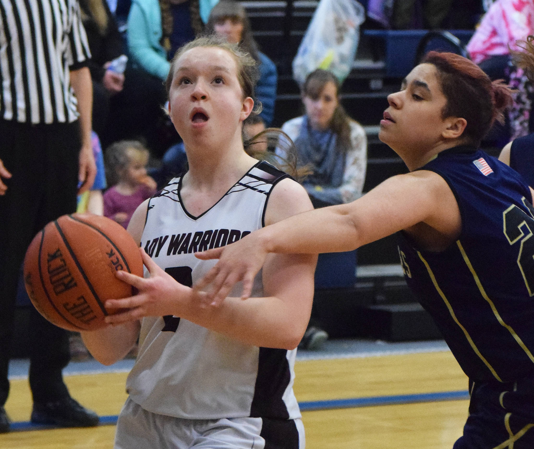 Nikolaevsk’s Sophia Klaich (left) drives by Ninilchik defender Jade Robuck Saturday in the Peninsula Conference girls second-place contest. (Photo by Joey Klecka/Peninsula Clarion)