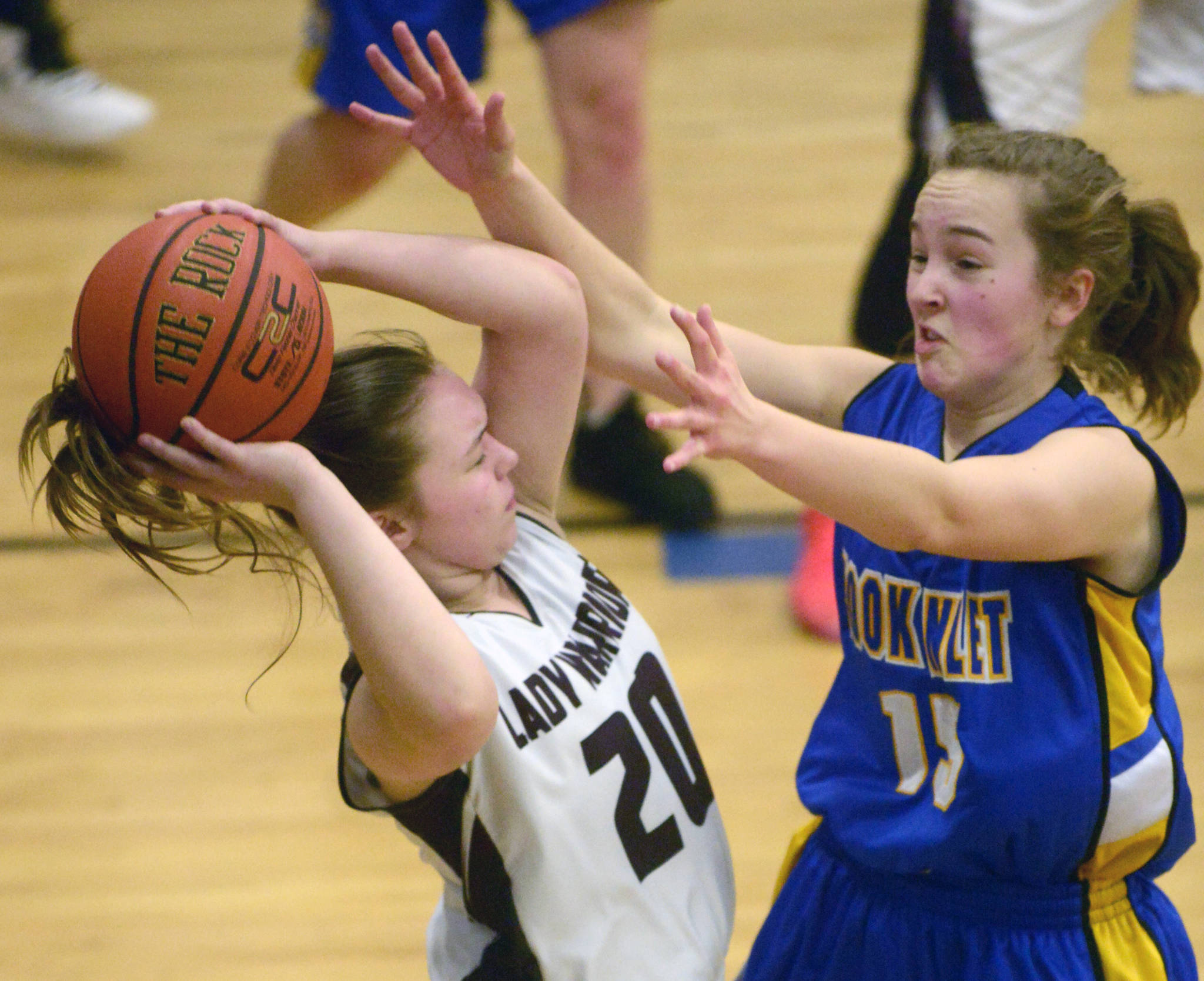 Cook Inlet Academy’s Addie Nelson pressures Nikolaevsk’s Krystyana Kalugin on Friday, March 1, 2019, during the Peninsula Conference girls championship at Cook Inlet Academy in Soldotna. (Photo by Jeff Helminiak/Peninsula Clarion)