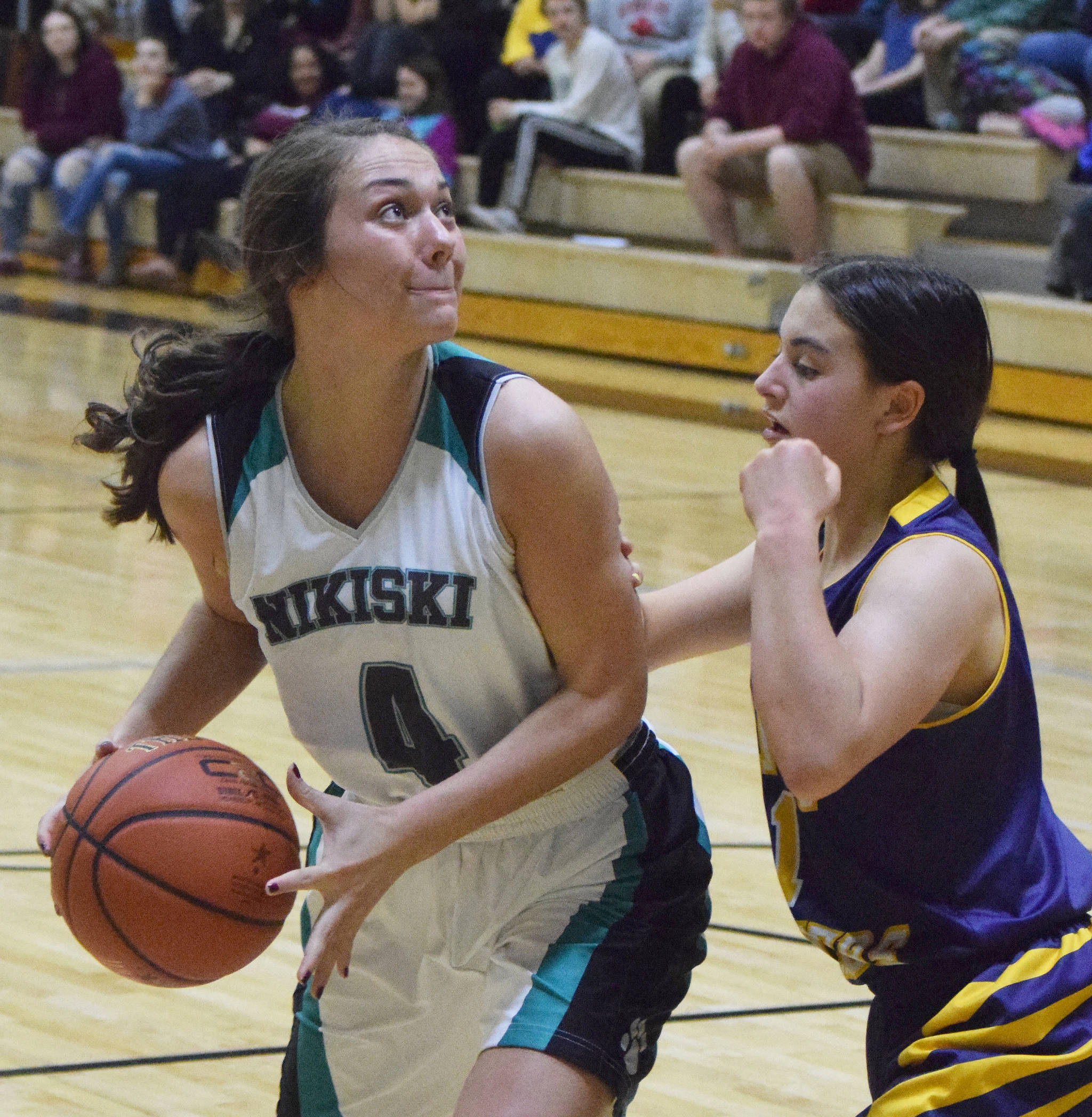 Nikiski senior Emma Wik (left) eyes the rim with Homer defender Sailey Rhodes guarding her Friday night in a Southcentral Conference clash at Nikiski High School. (Photo by Joey Klecka/Peninsula Clarion)