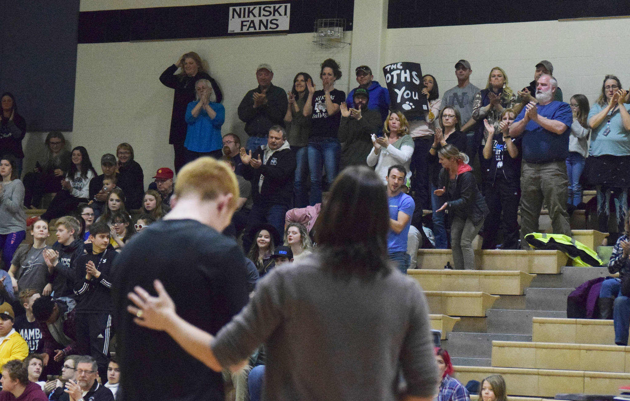 A crowd of Nikiski supporters give a standing ovation for the senior class Friday night at Nikiski High School. The evening also celebrated the memory of the late Rus Hitchcock, a longtime coaching presence in the Nikiski community who passed away in October 2017. (Photo by Joey Klecka/Peninsula Clarion)