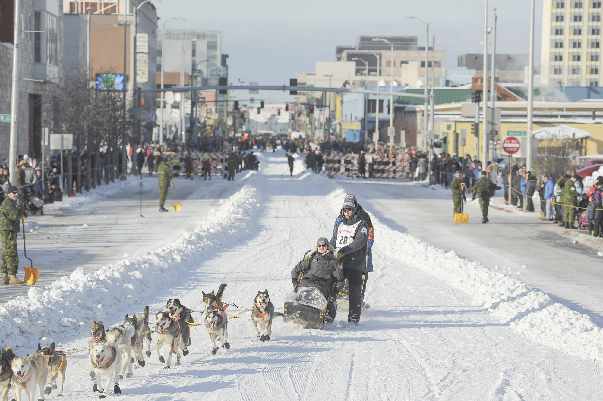Defending champion Joar Lefseth Ulsom runs his team down Fourth Ave during the ceremonial start of the Iditarod Trail Sled Dog Race Saturday in Anchorage. (AP Photo/Michael Dinneen)