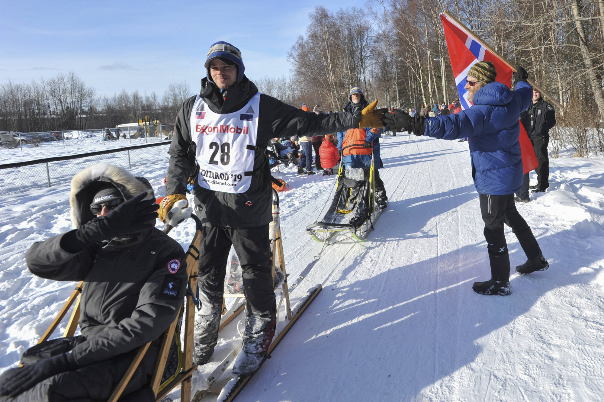 Defending champion Joar Leifseth Ulsom is greeted by local fan Ole Andersson during the ceremonial start of the Iditarod Trail Sled Dog Race Saturday in Anchorage. (AP Photo/Michael Dinneen)                                Defending champion Joar Leifseth Ulsom is greeted by local fan Ole Andersson during the ceremonial start of the Iditarod Trail Sled Dog Race Saturday, March 2, 2019 in Anchorage, Alaska. (AP Photo/Michael Dinneen)