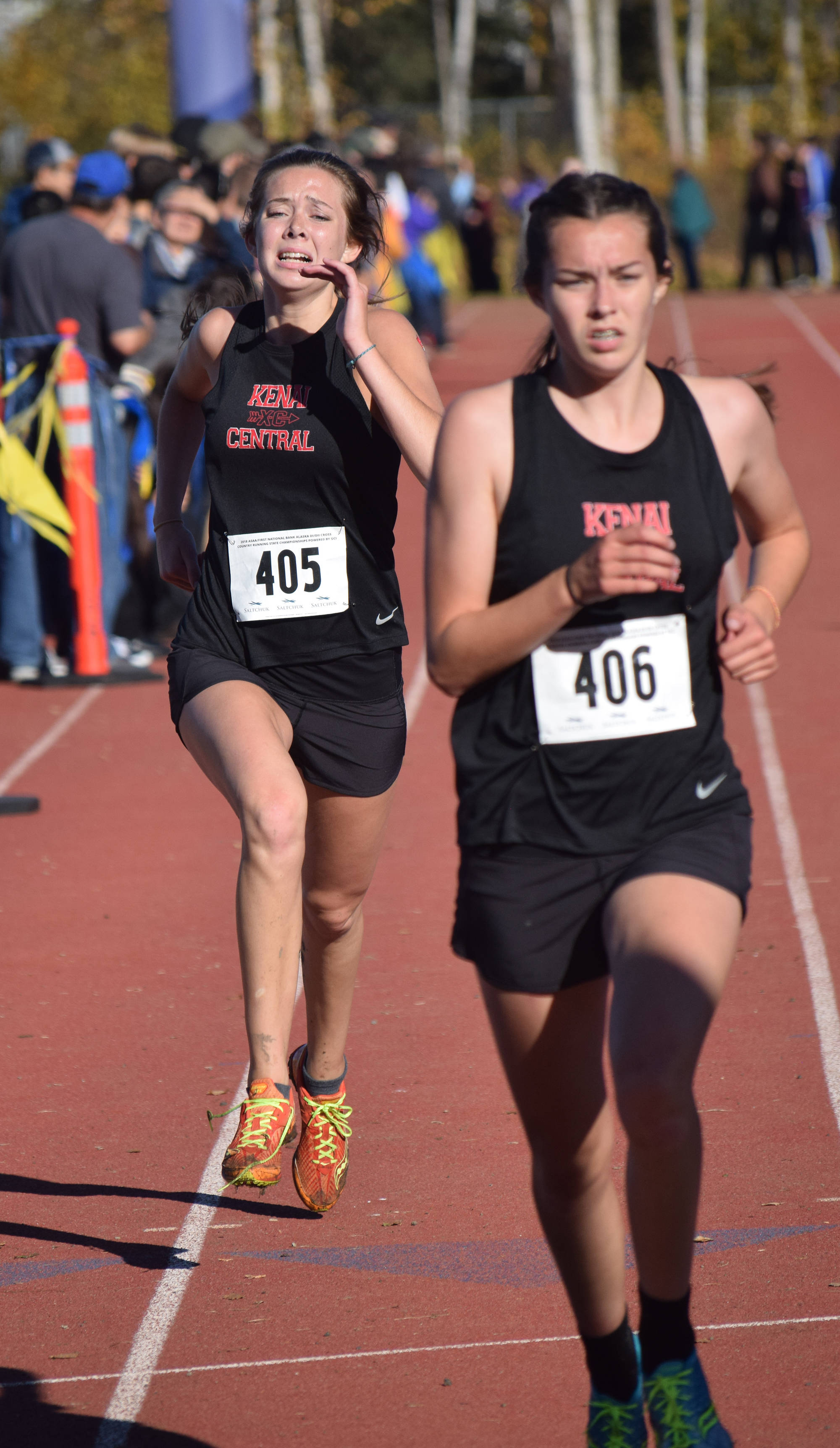Kenai Central sister duo Brooke (left) and Logan Satathite sprint to the finish of the Division II girls race this fall at the ASAA state cross-country running championships at the Bartlett Trails in Anchorage. (Photo by Joey Klecka/Peninsula Clarion)