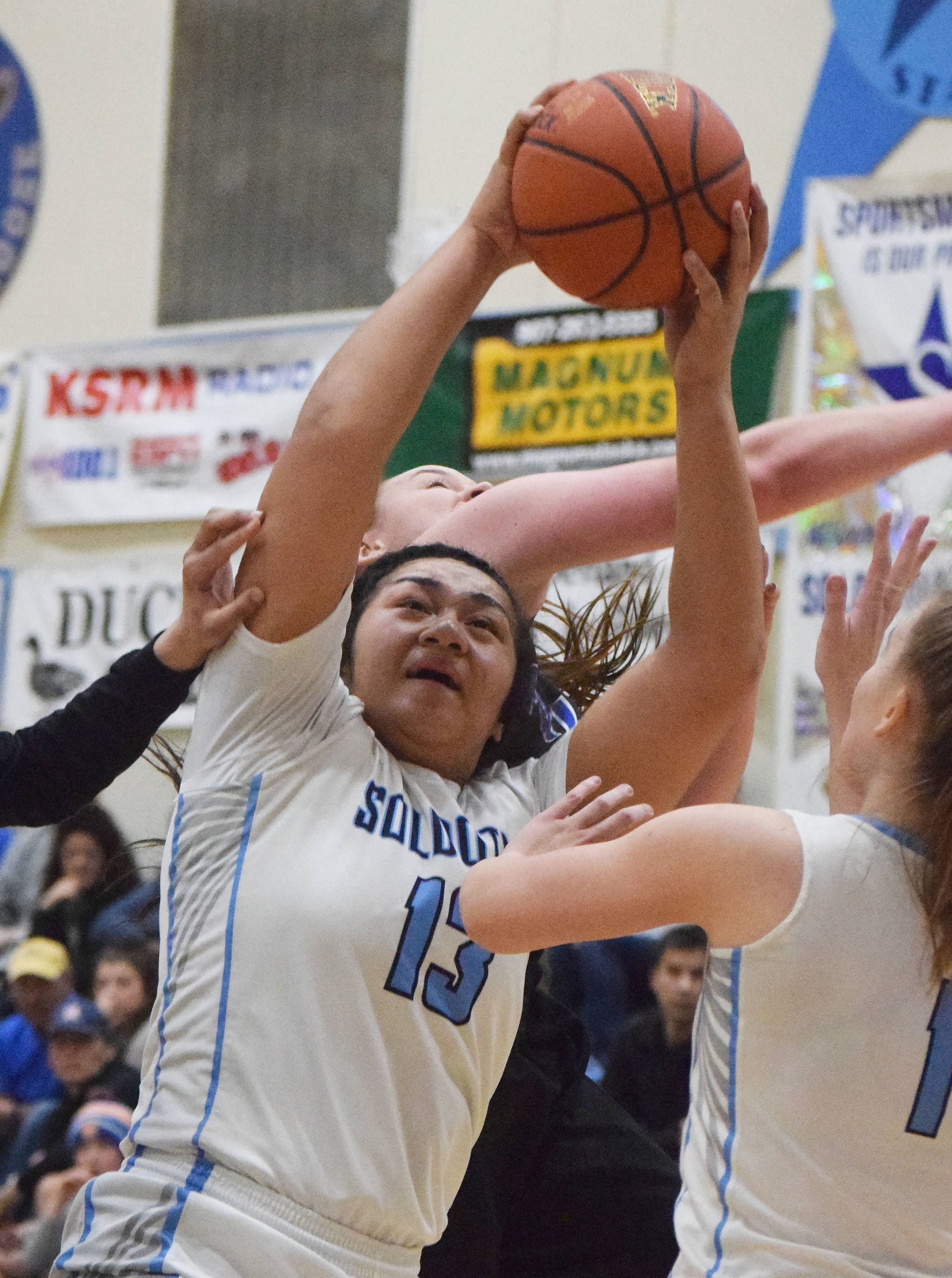 Soldotna’s Ituau Tuisaula (13) grabs a rebound Friday night in the Northern Lights Conference semifinals against Palmer at Soldotna High School. (Photo by Joey Klecka/Peninsula Clarion)