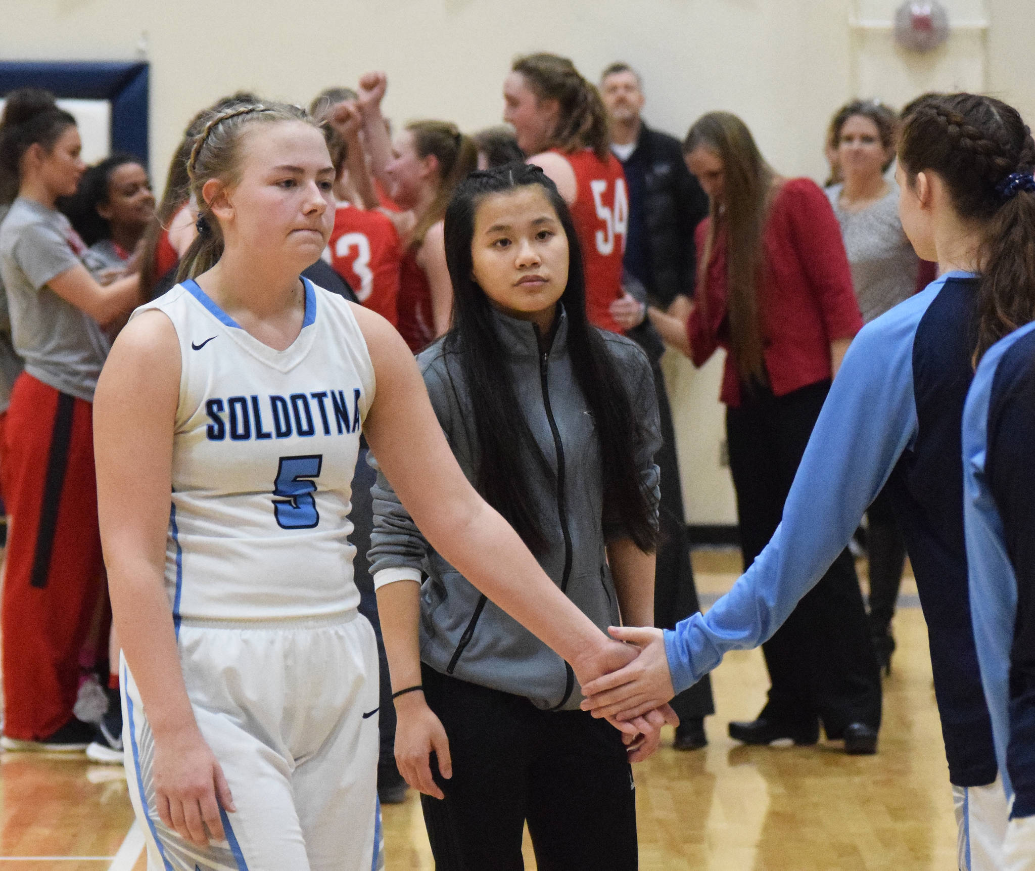 Soldotna senior Brittani Blossom (5) receives a comforting gesture following Soldotna’s loss to Wasilla in Saturday’s Northern Lights Conference girls championship game at Soldotna High School. (Photo by Joey Klecka/Peninsula Clarion)