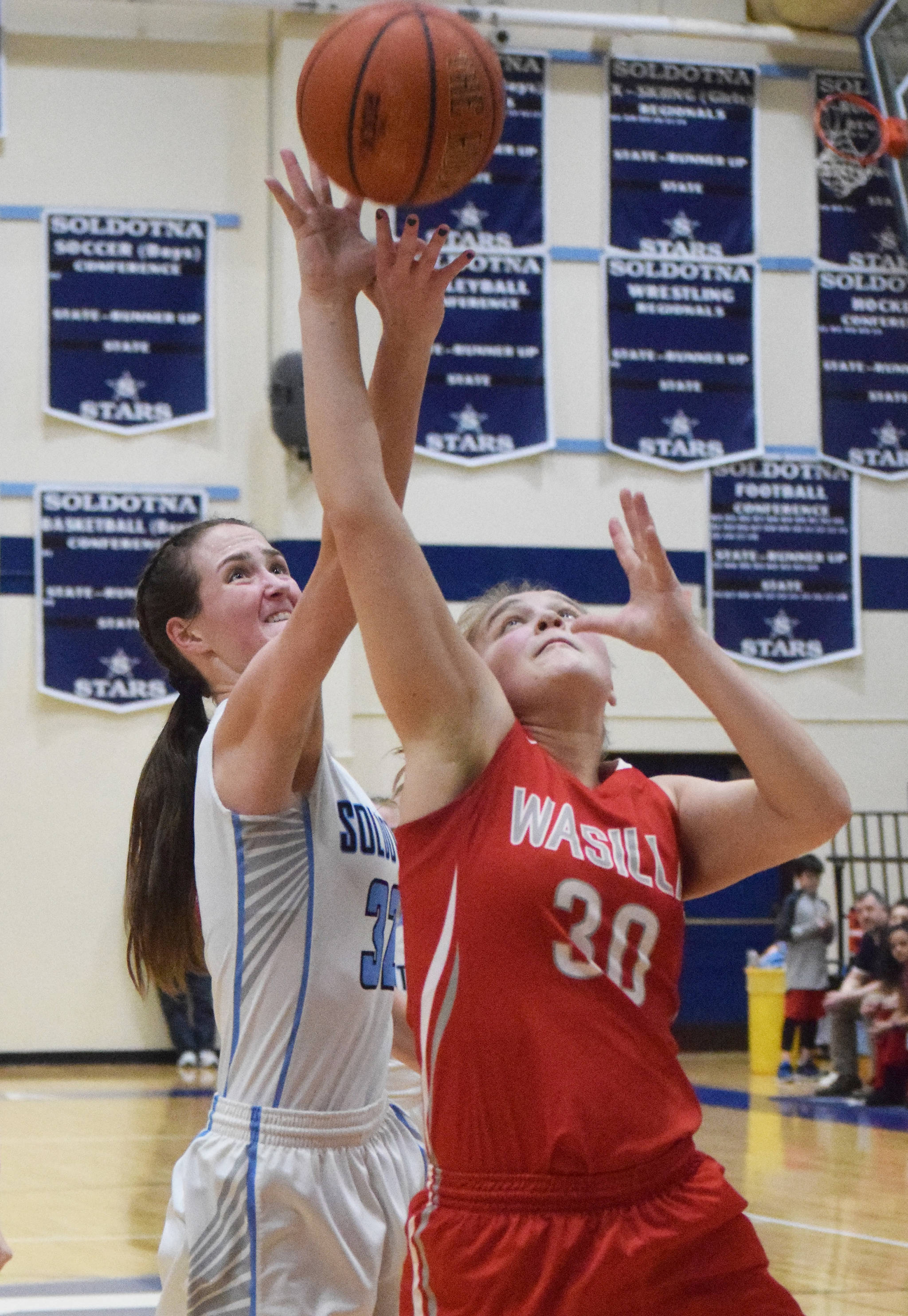 Wasilla’s Diondra Lawhead attempts to block a shot from Soldotna’s Danica Schmidt Saturday in the Northern Lights Conference girls championship at Soldotna High School. (Photo by Joey Klecka/Peninsula Clarion)