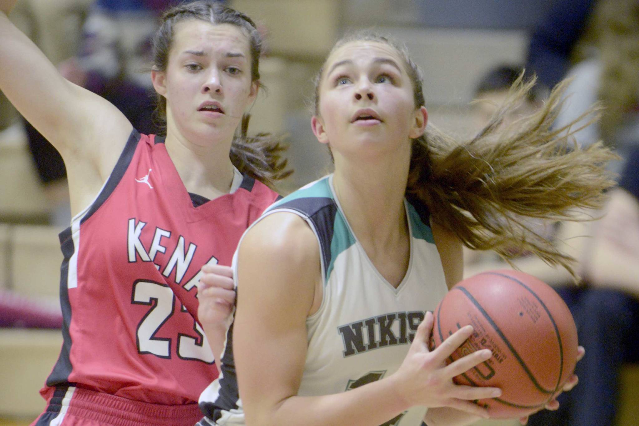 Nikiski’s Kaitlyn Johnson goes up for a shot against Kenai Central’s Logan Satathite on Friday, Feb. 1, 2019, at Nikiski High School. (Photo by Jeff Helminiak/Peninsula Clarion)