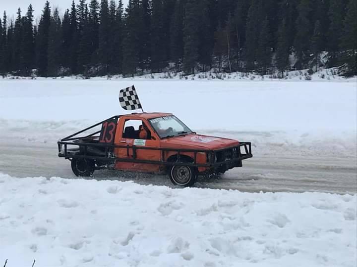 Owner/driver JT Hawkins in his #13 car sporting the checkered flag. (Photo provided by Kenai Peninsula Ice Race Association)