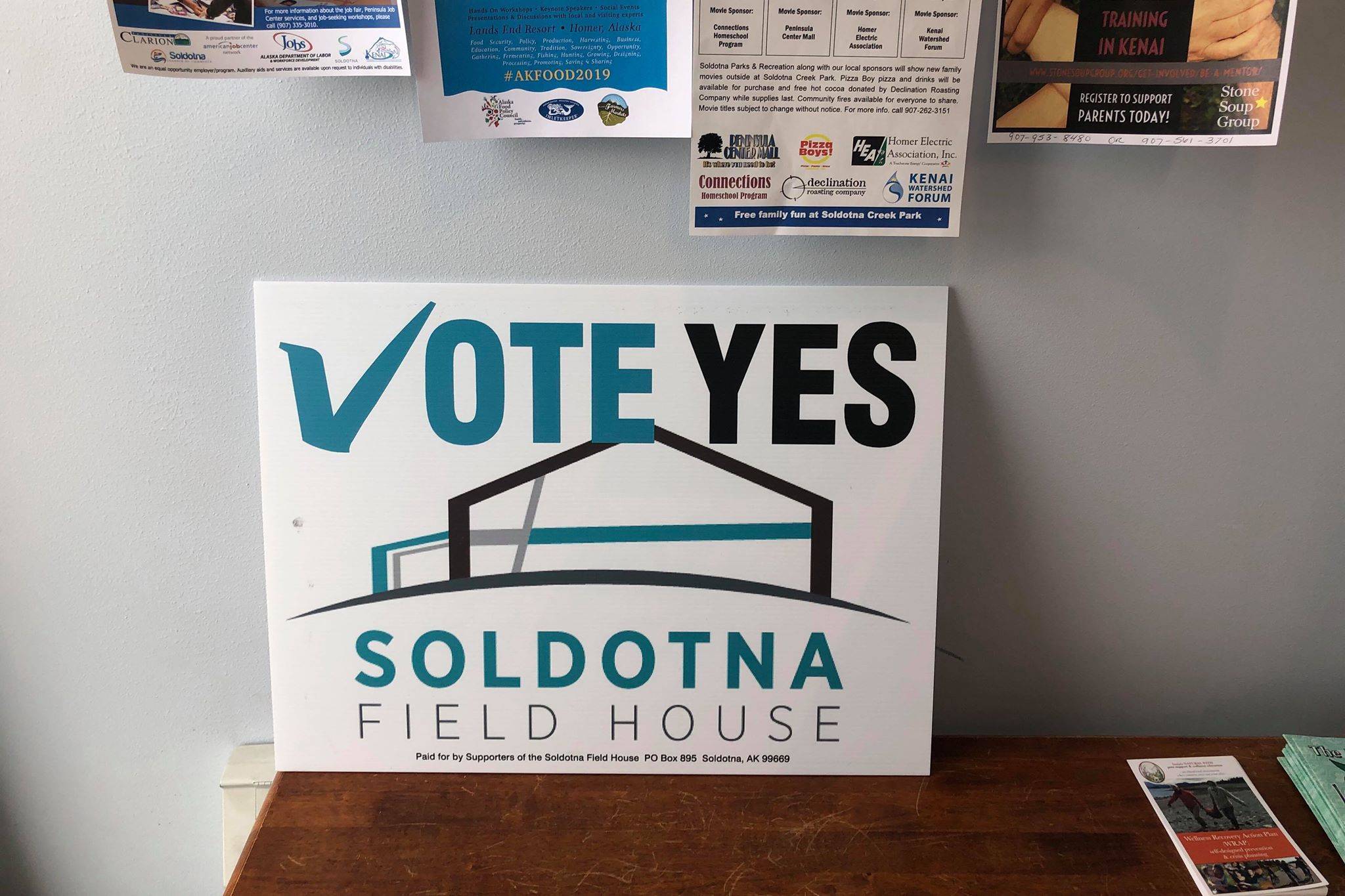 A sign supporting the Soldotna field house proposition sits inside local cafe, Everything Bagels, in Soldotna, Alaska, on Wednesday, Feb. 27, 2019. (Photo by Victoria Petersen/Peninsula Clarion)