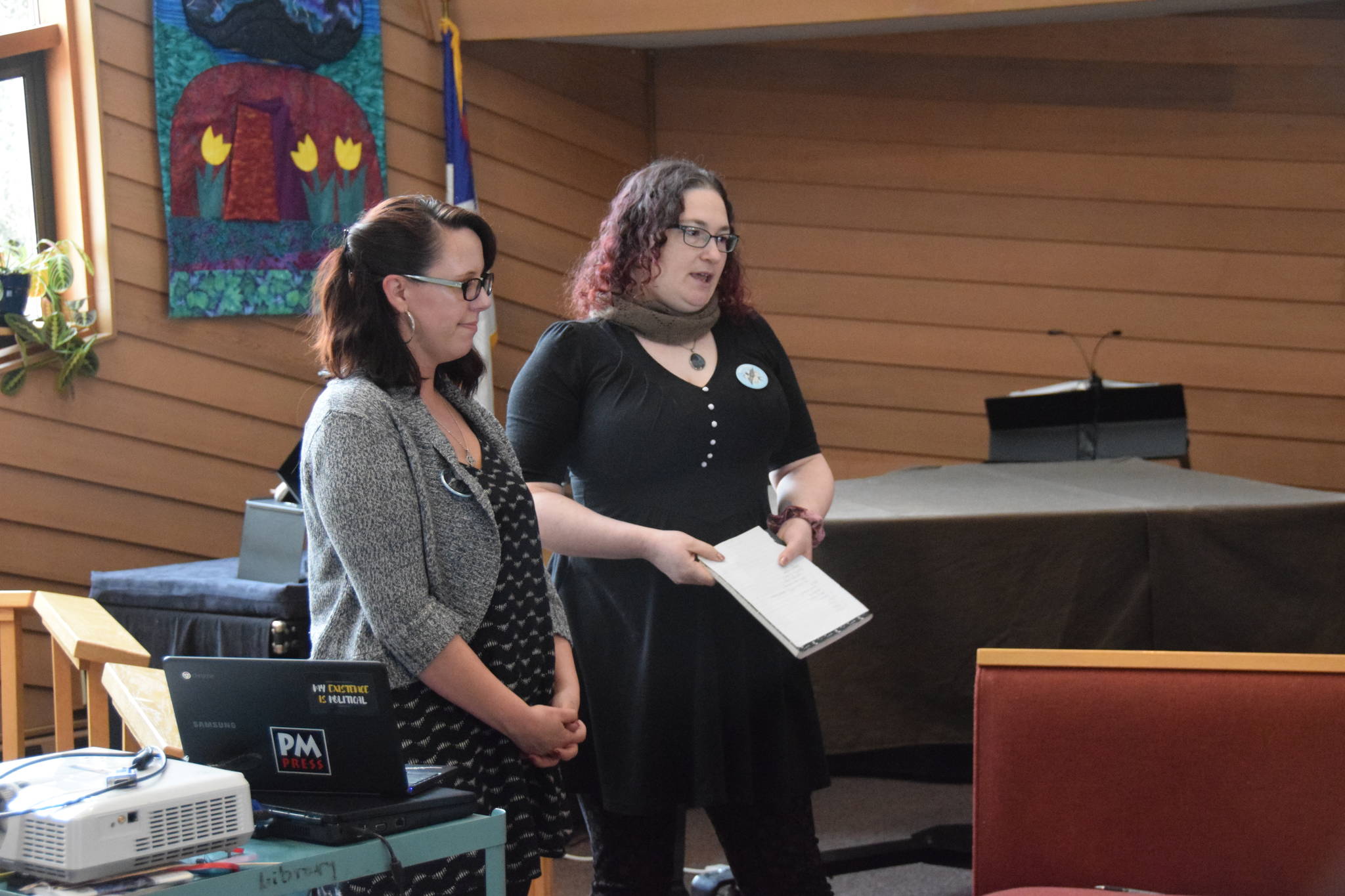 Amber Batts (left) and Terra Burns (right) speak to residents on behalf of CUSP at the Christ Lutheran Church in Soldotna on March 11, 2019. (Photo by Brian Mazurek/Peninsula Clarion)