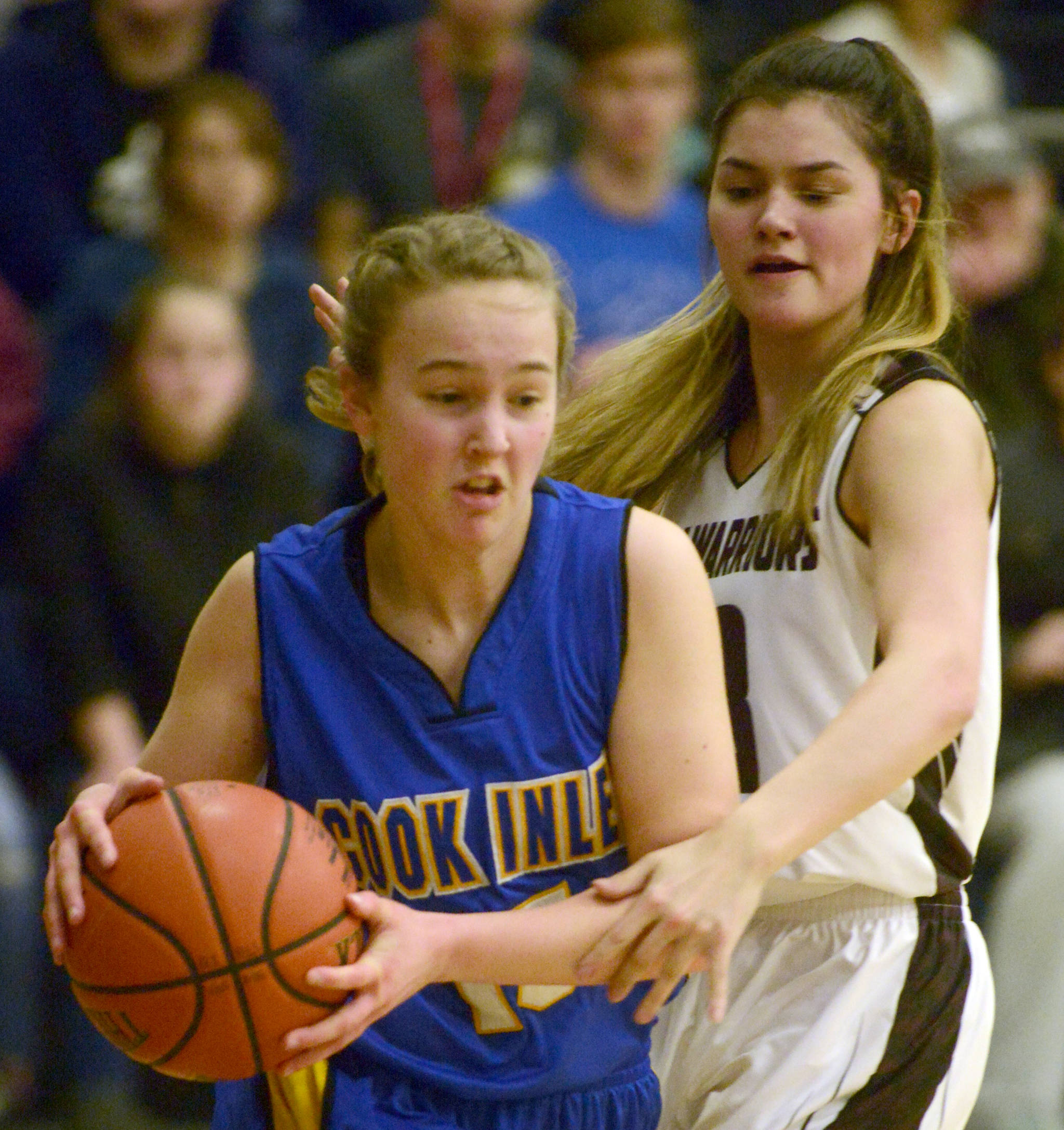 Cook Inlet Academy’s Addie Nelson drives on Nikolaevsk’s Justina Fefelov on Friday, March 1, 2019, in the Peninsula Conference finals at Cook Inlet Academy. (Photo by Jeff Helminiak/Peninsula Clarion)