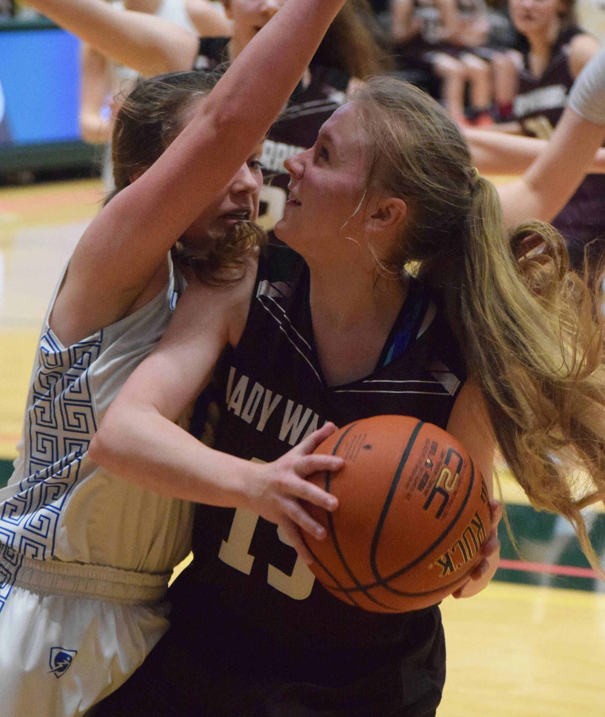 Nikolaevsk’s Markiana Yakunin (right) drives to the rim against Tri-Valley’s Jazmyn Byfluglien Thursday at the Class 1A girls state basketball tournament in Anchorage. (Photo by Joey Klecka/Peninsula Clarion)