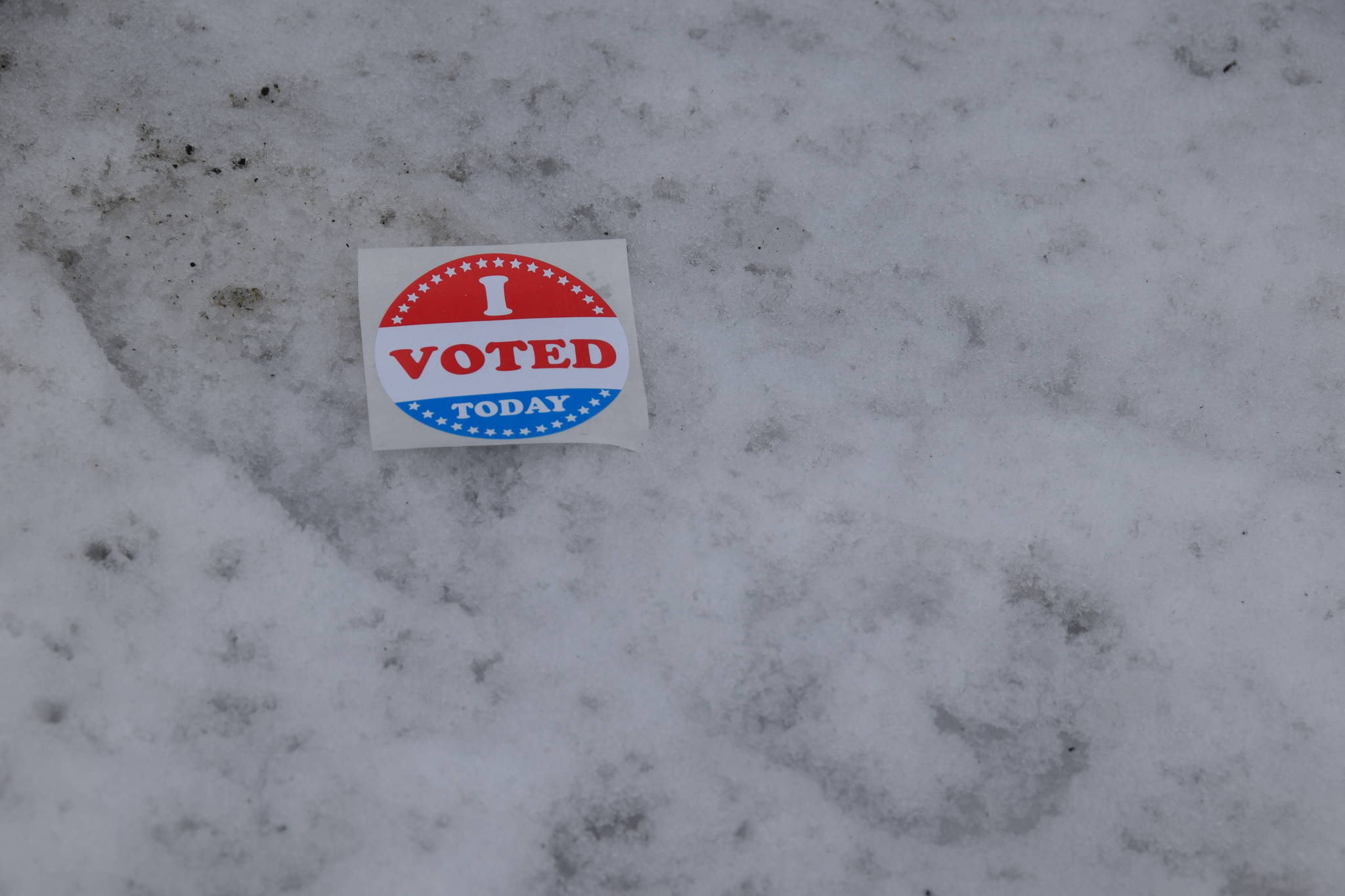 An “I voted” sticker lays abandoned outside Soldotna City Hall during the special Field House election on March 5, 2019. (Photo by Brian Mazurek/Peninsula Clarion)