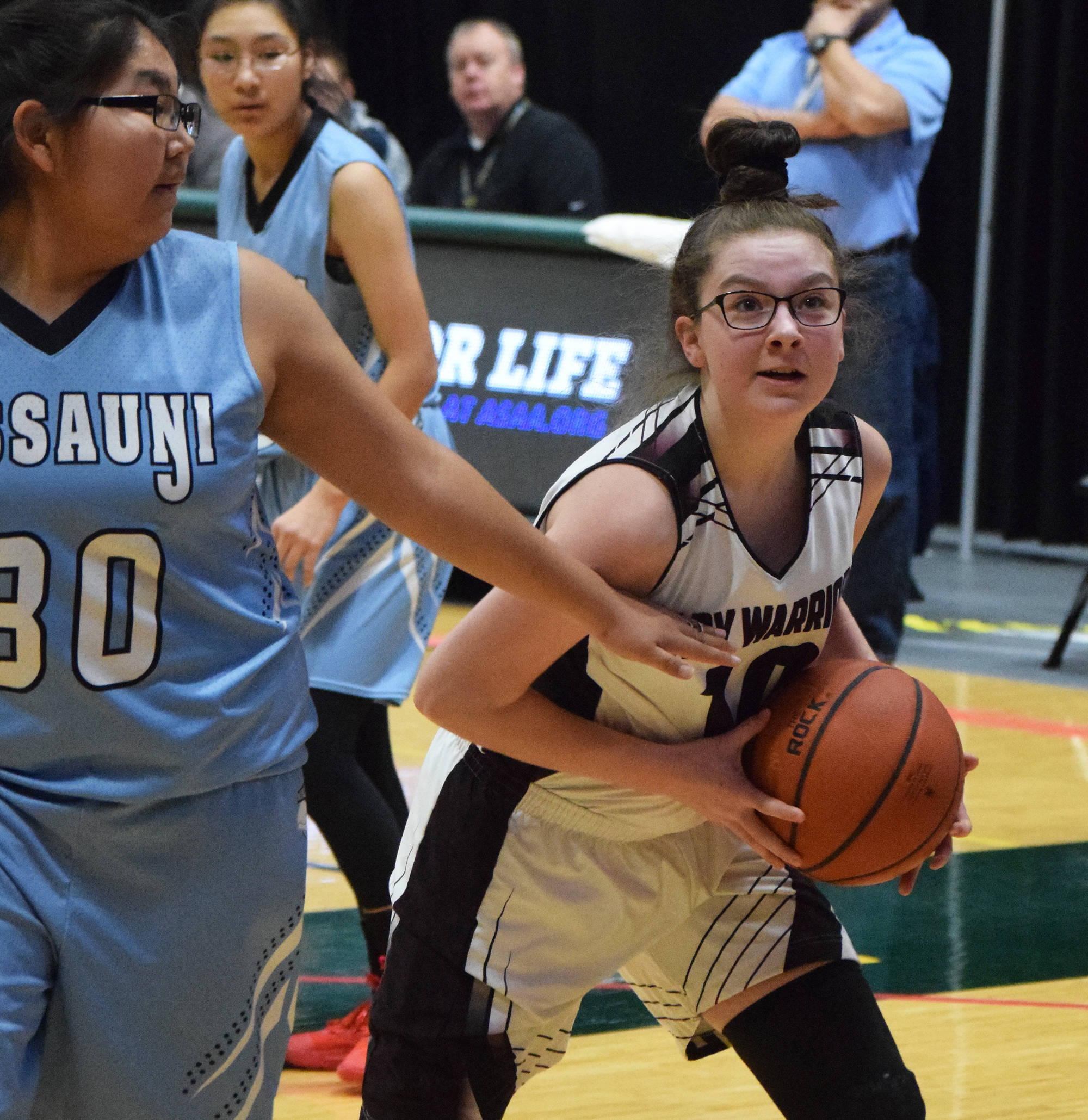 Nikolaevsk’s Zoya Fefelov (right) drives to the rim against Buckland’s Destiny Hadley Friday at the Class 1A state tournament at the Alaska Airlines Center in Anchorage. (Photo by Joey Klecka/Peninsula Clarion)