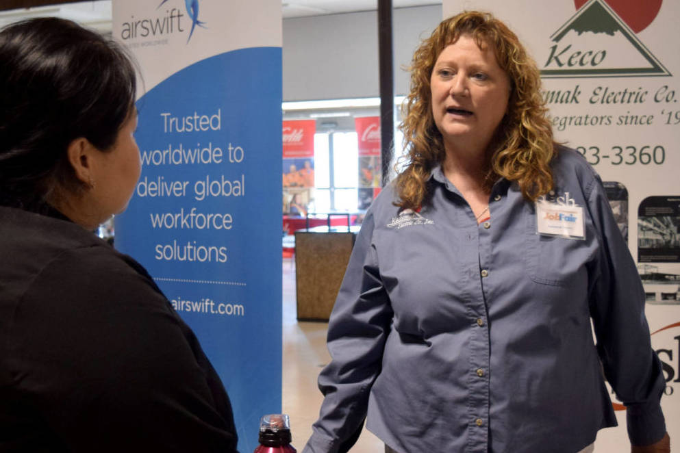 Gina Keith, office manager at Kachemak Electric, speaks with job seekers at the 2017 Kenai Peninsula Job Fair (Kat Sorensen/Peninsula Clarion)