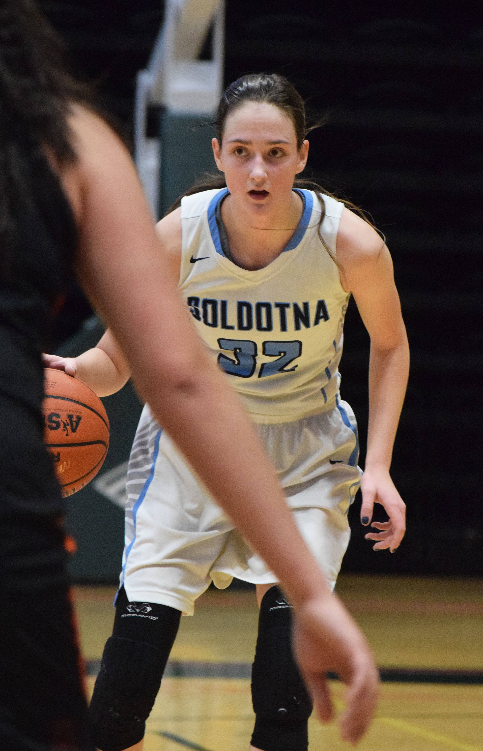 Soldotna’s Danica Schmidt surveys the West Anchorage defense Thursday, Mar. 21, 2019, at the Class 4A state championship tournament at the Alaska Airlines Center in Anchorage. (Photo by Joey Klecka/Peninsula Clarion)