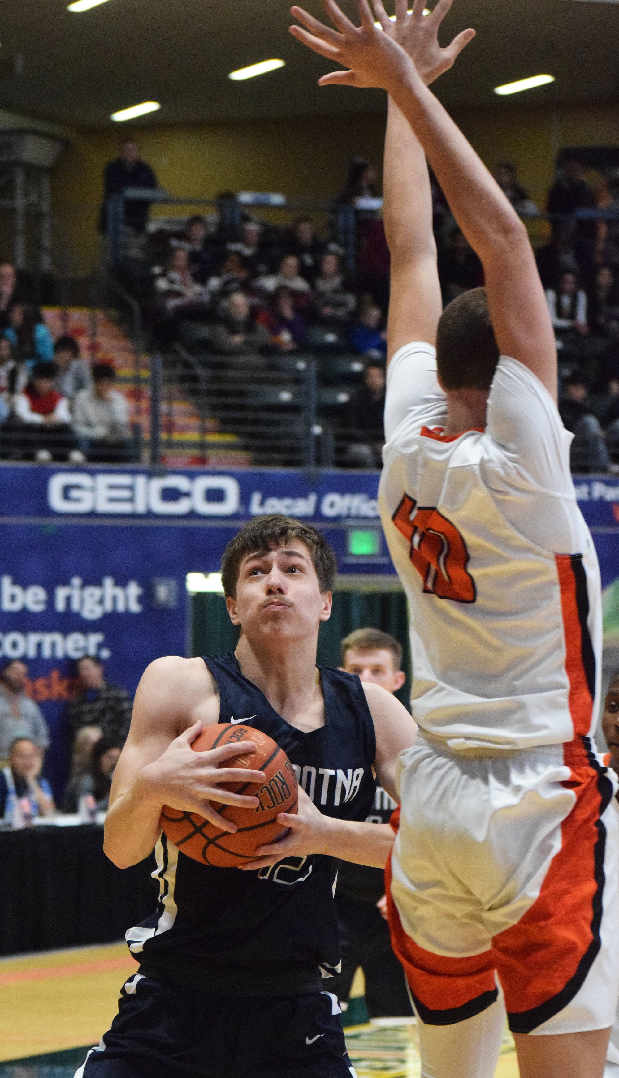 Soldotna’s Jersey Truesdell (left) jukes to the right of West defender Traivar Jackson, Thursday, Mar. 21, 2019, at the Class 4A state championship tournament at the Alaska Airlines Center in Anchorage. (Photo by Joey Klecka/Peninsula Clarion)