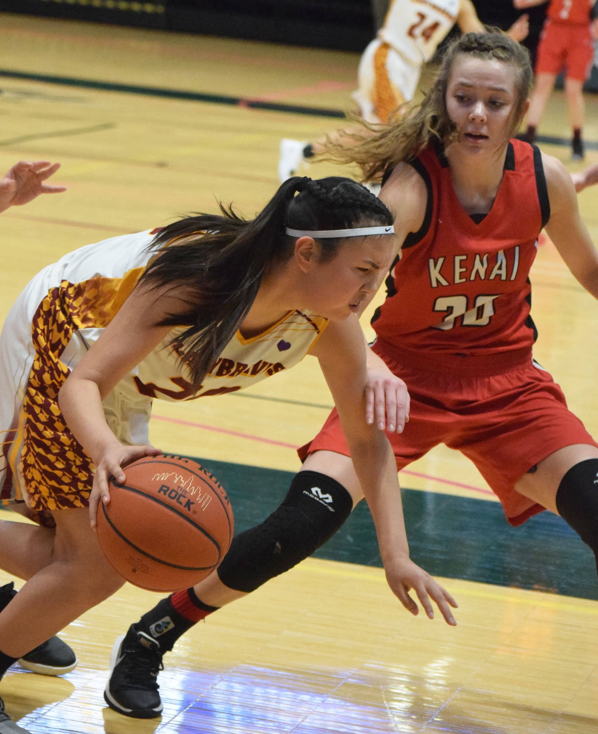Mt. Edgecumbe’s Autumn Beans (left) tries to evade the defense of Kenai’s Brooke Satathite, Thursday, Mar. 21, 2019, at the Class 3A state championship tournament at the Alaska Airlines Center in Anchorage. (Photo by Joey Klecka/Peninsula Clarion)