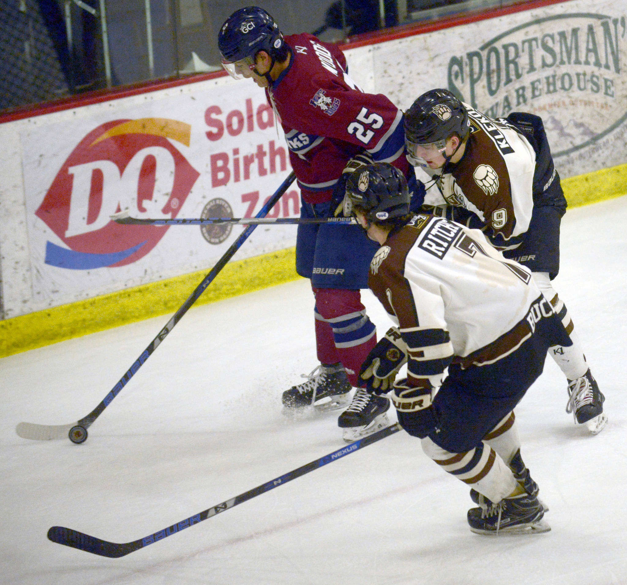 Fairbanks Ice Dogs defenseman Trenton Woods keeps the puck away from Kenai River Brown Bears forwards Logan Ritchie and Alex Klekotka on Thursday, March 21, 2019, at the Soldotna Regional Sports Complex. (Photo by Jeff Helminiak/Peninsula Clarion)