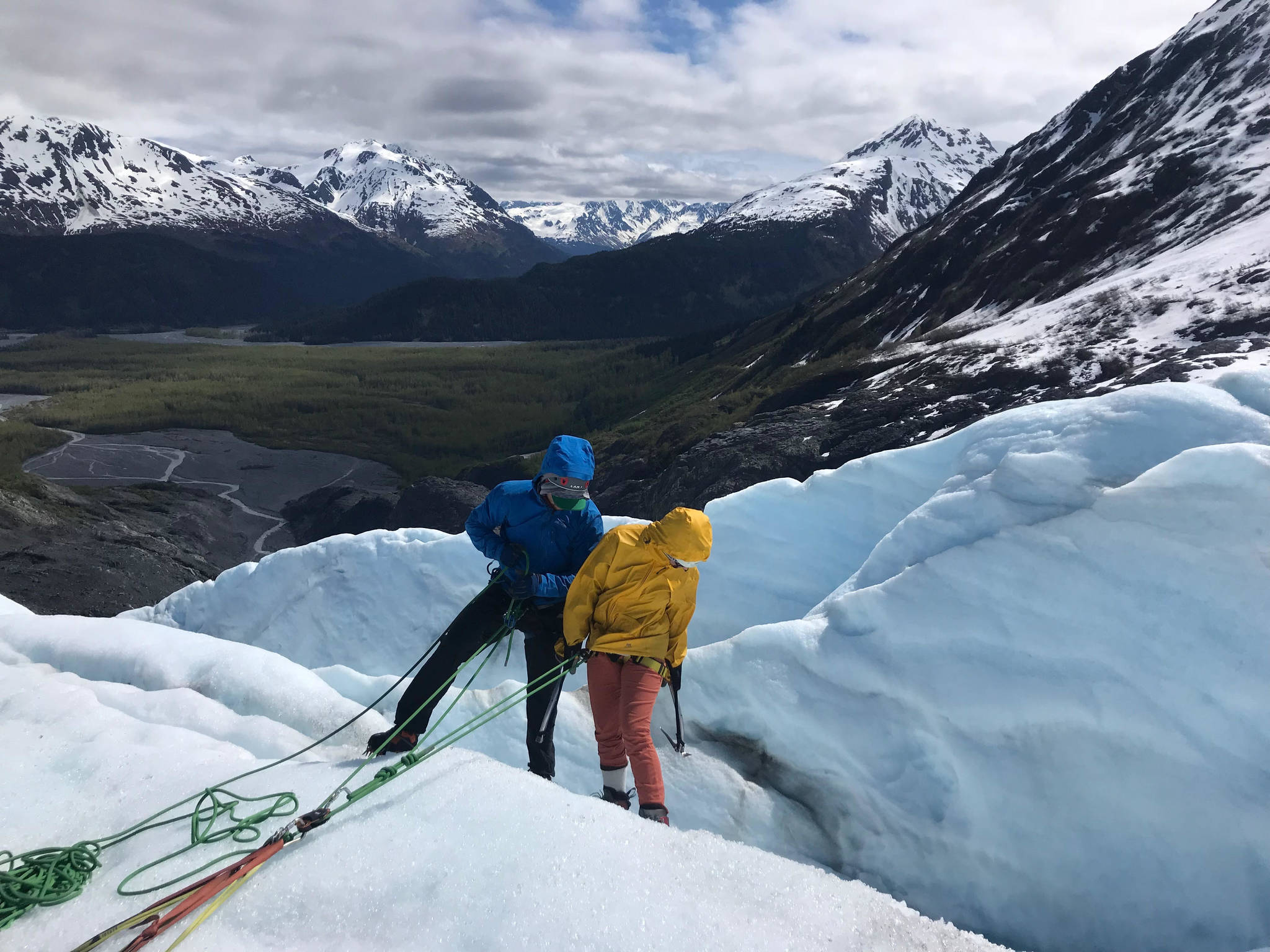 Exit Glacier Guides operates daily ice climbing trips on Exit Glacier outside of Seward during the summer months. A guide is seen here, leading a visitor to Seward on a climbing trip into a glacial crevasse in summer 2018. (Photo by Kat Sorensen/Peninsula Clarion).
