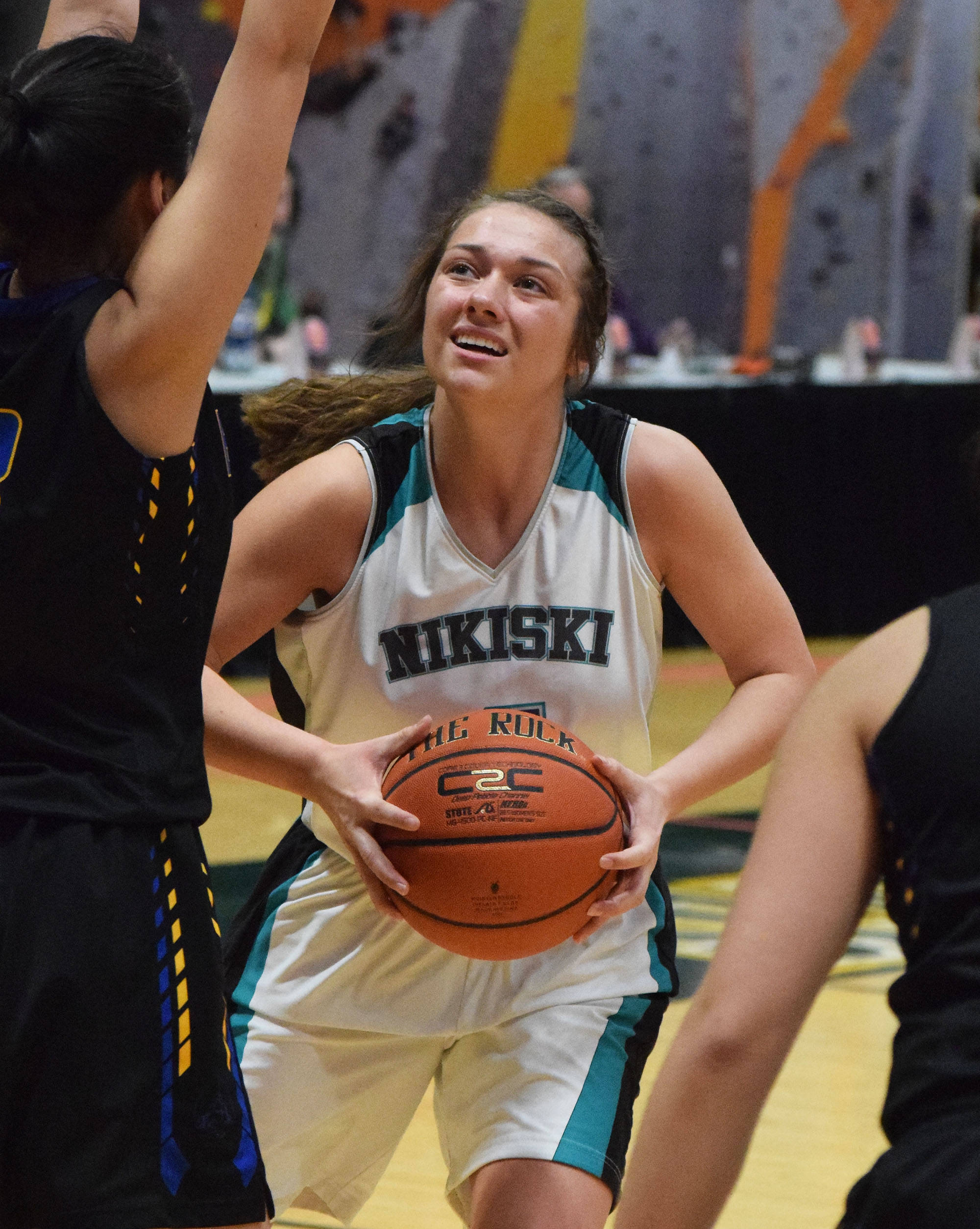 Nikiski’s Emma Wik looks for the open shot Friday, March 22, 2019, against Barrow at the Class 3A girls state tournament at the Alaska Airlines Center in Anchorage. (Photo by Joey Klecka/Peninsula Clarion)