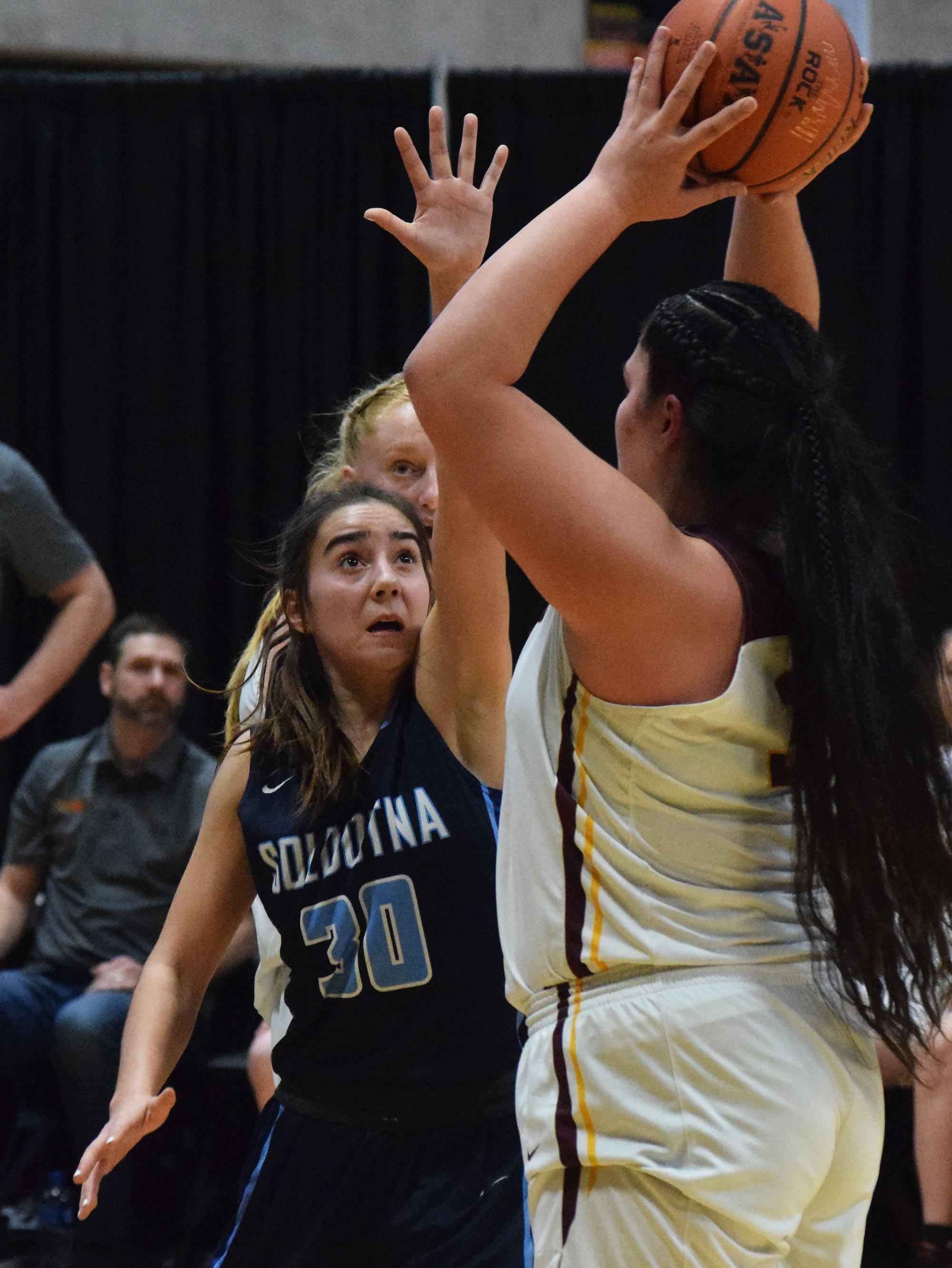 Soldotna’s Drysta Crosby-Schneider (30) puts up a block against Dimond’s Alissa Pili Friday, March 22, 2019, in the Class 4A state basketball tournament at the Alaska Airlines Center in Anchorage. (Photo by Joey Klecka/Peninsula Clarion)