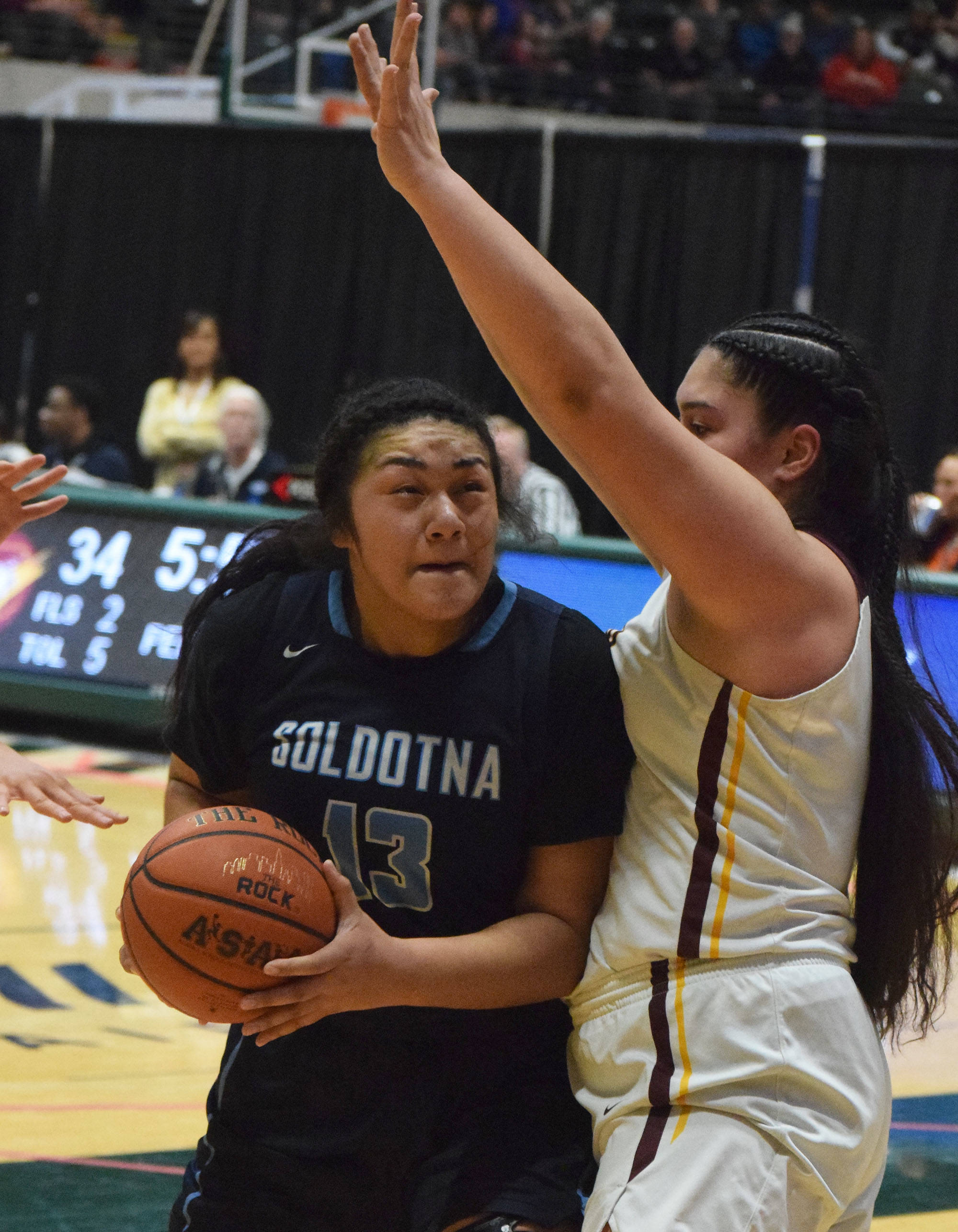 Soldotna Ituau Tuisaula (left) drives the lane by Dimond’s Alissa Pili Friday, March 22, 2019, in the Class 4A state basketball tournament at the Alaska Airlines Center in Anchorage. (Photo by Joey Klecka/Peninsula Clarion)