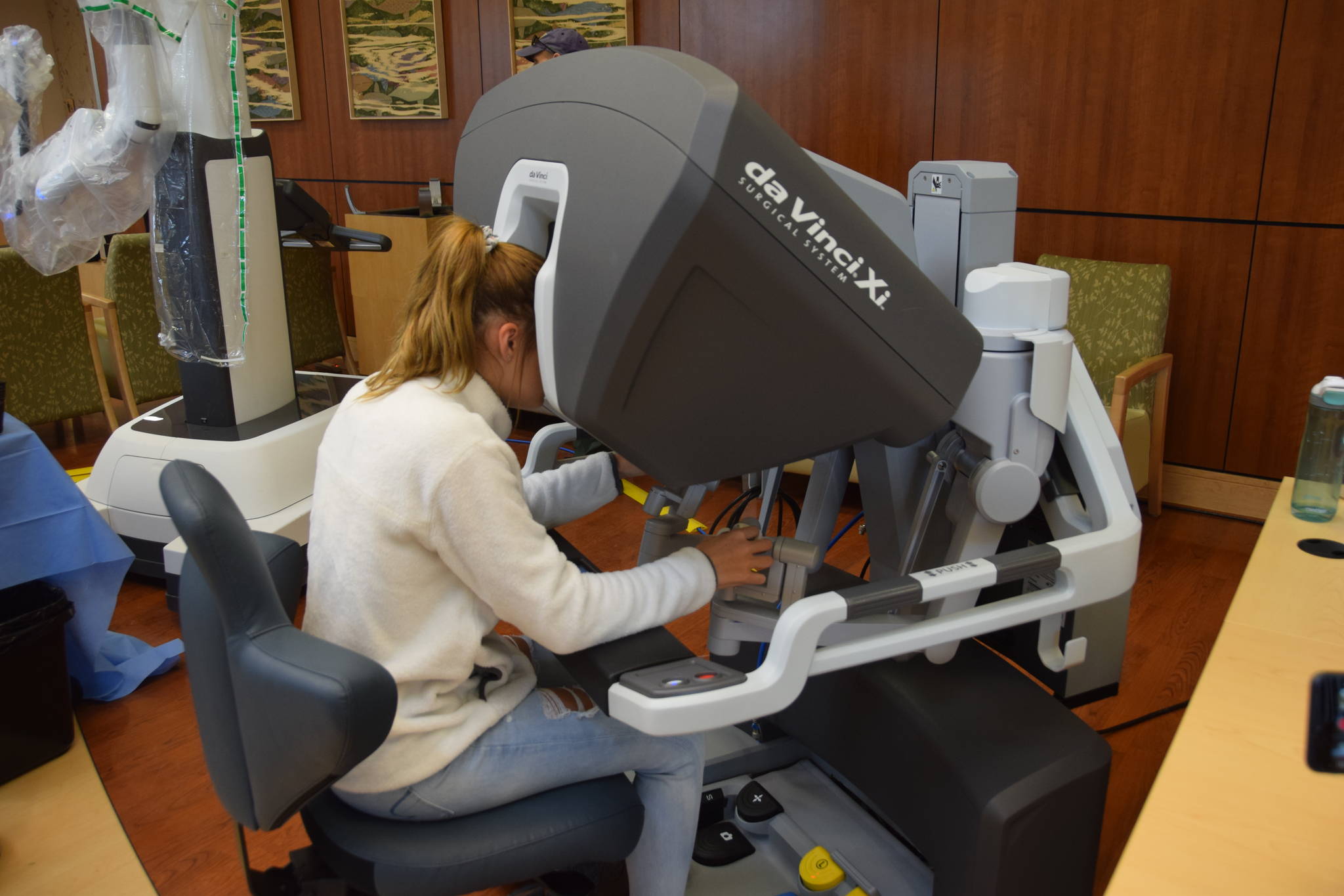 Peninsula resident Willow Kitchens tests out the Da Vinci Xi surgery robot during the Community Health Fair at Central Peninsula Hospital in Soldotna, Alaska, on March 23, 2019. (Photo by Brian Mazurek/Peninsula Clarion)