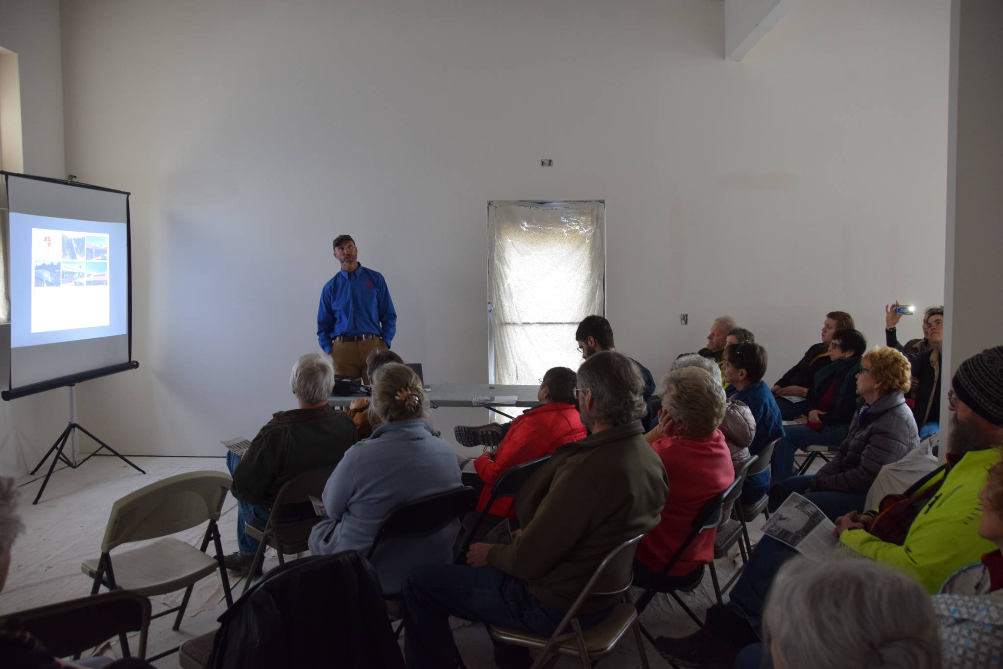 Ben May, owner of Anchorage Solar gives a presentation about solar technology to peninsula residents at the new River City Books location in Soldotna on Saturday. (Photo by Brian Mazurek/Peninsula Clarion)