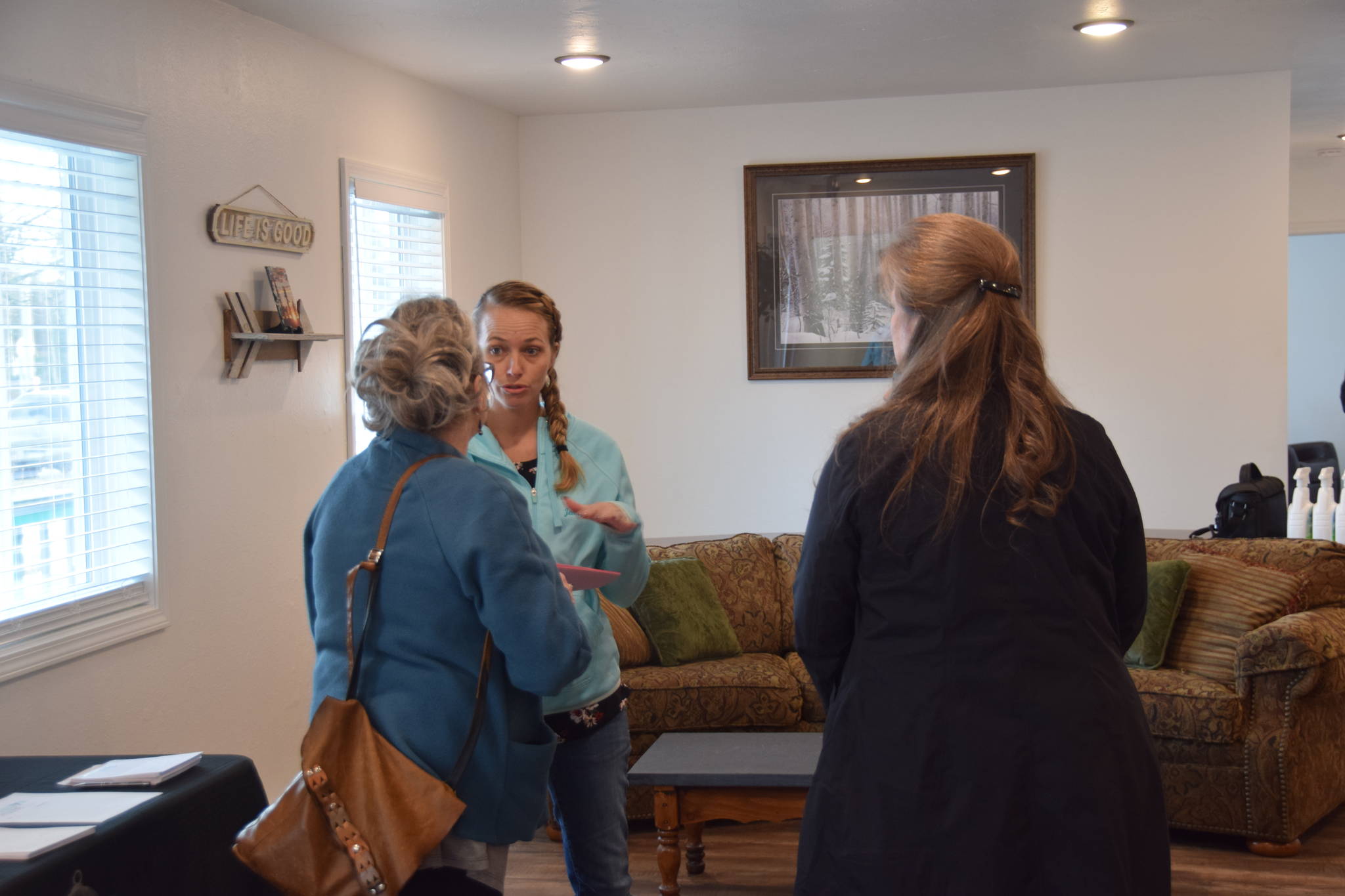 Jennifer Waller of Freedom House, center, speaks with members of the community during the opening of Freedom House’s men’s residence in Soldotna, Alaska, on March 24, 2019. (Photo by Brian Mazurek/Peninsula Clarion