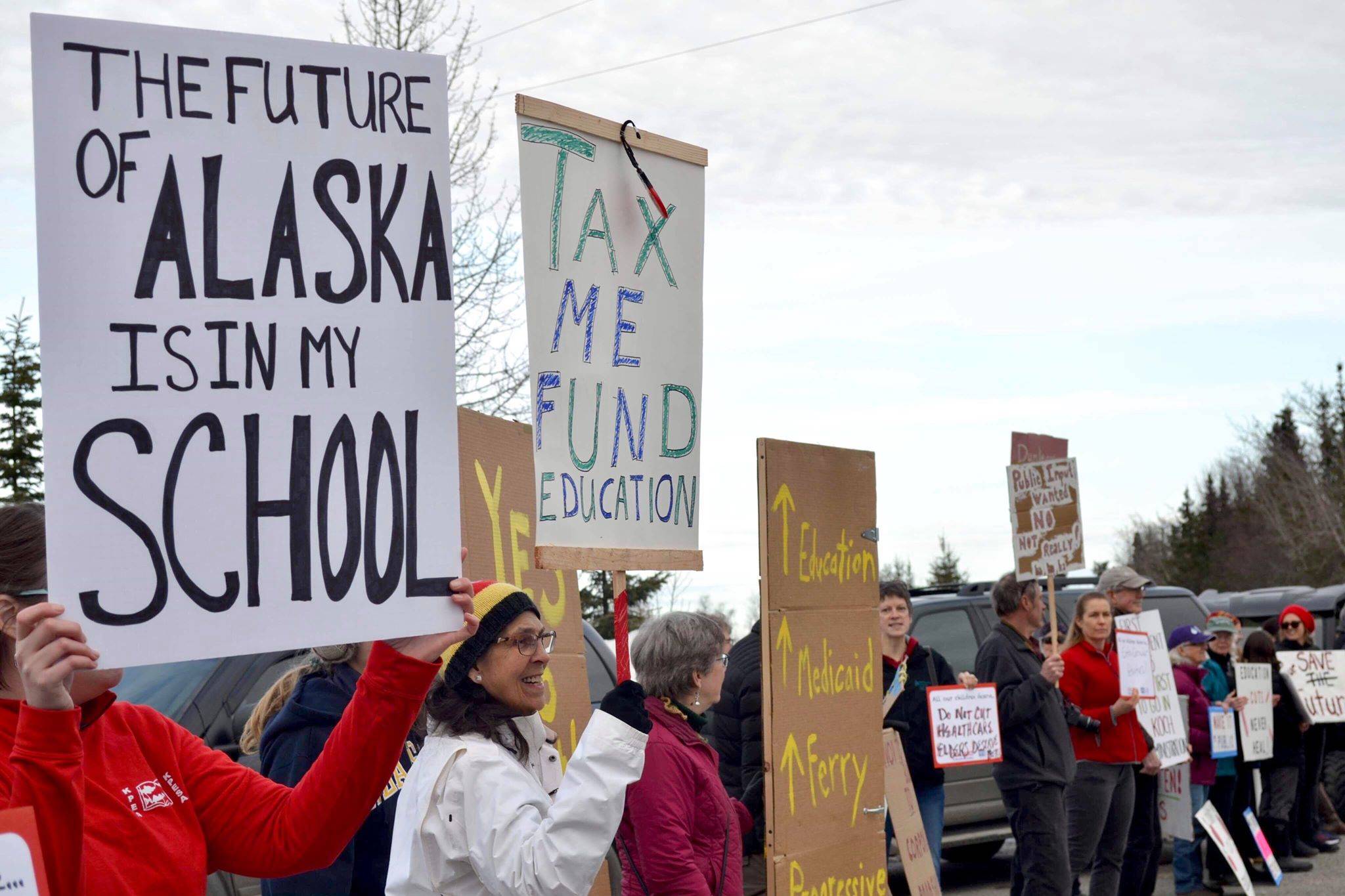 Protesters stand outside the Cannery Lodge in Kenai, Alaska, ahead of Gov. Mike Dunleavy’s presentation about his proposed budget on March 26, 2019. (Photo by Victoria Petersen/Peninsula Clarion)