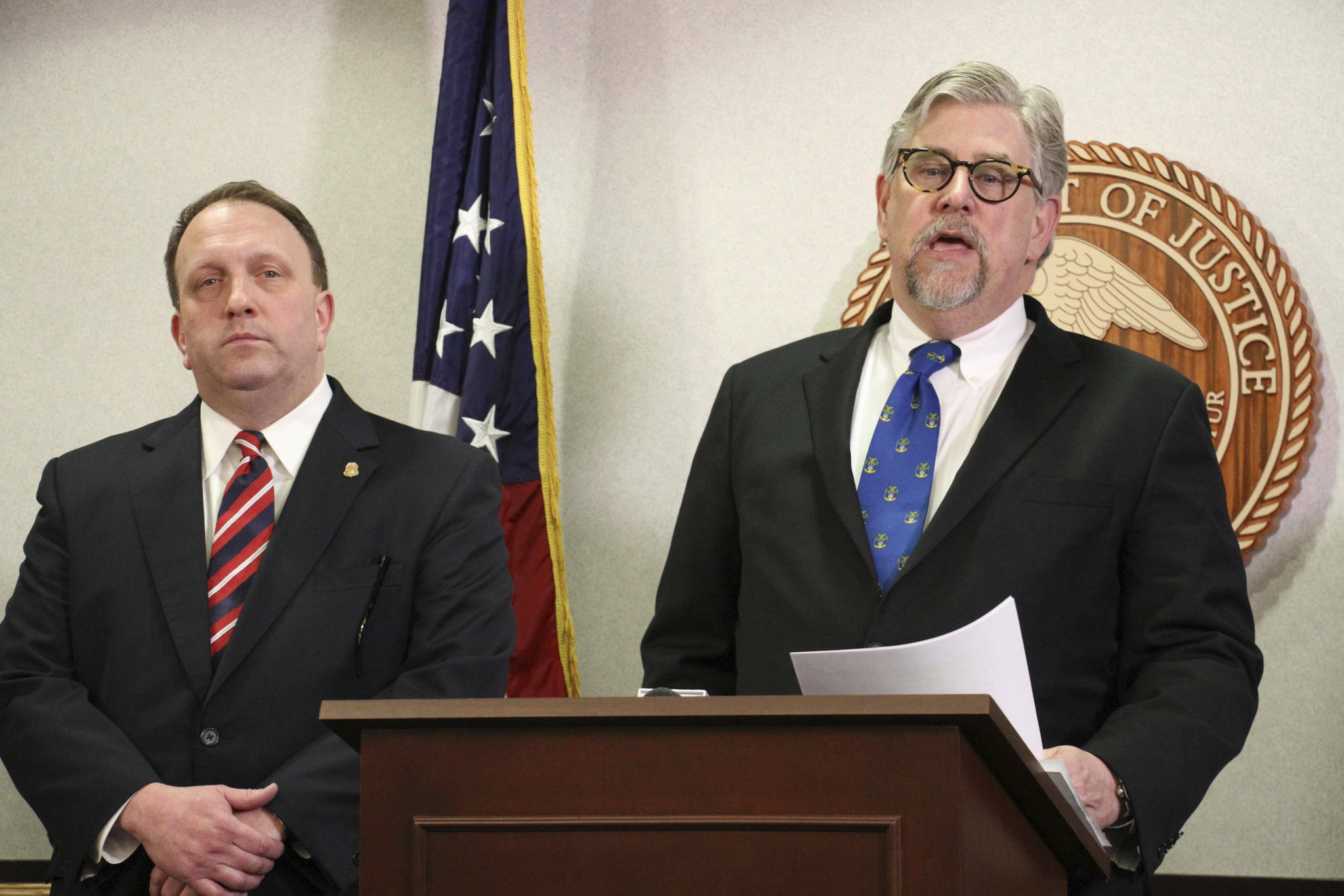 Jeffery Peterson, special agent in charge of the Anchorage FBI office, left, and Bryan Schroder, Alaska’s U.S. Attorney, right, announce that several members of a white supremacist gang operating in Alaska prisons or shipped to facilities in Colorado and Arizona, have been charged in a racketing enterprise in Anchorage, Alaska, Wednesday, March 27, 2019. Members who sport Nazi tattoos face racketeering charges including murder, kidnapping, assault, and distribution of narcotics and firearms. (AP Photo/Mark Thiessen)