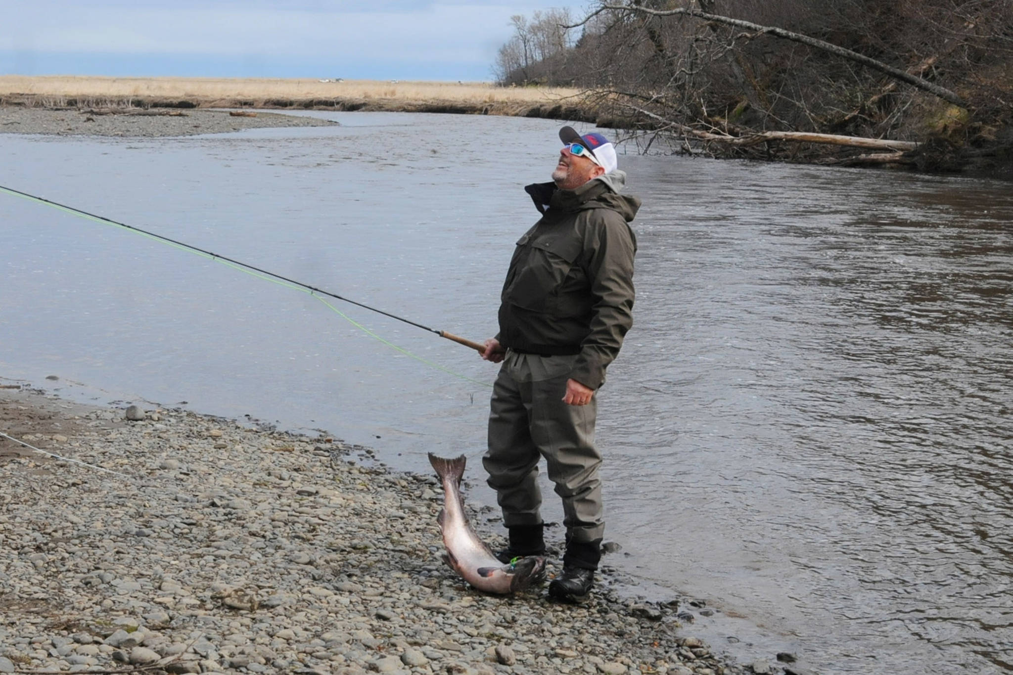 Terry Umatum of Anchorage takes a deep breath after landing his Anchor River king salmon on Saturday, May 19, 2018 in Anchor Point, Alaska. (Photo by Elizabeth Earl/Peninsula Clarion)