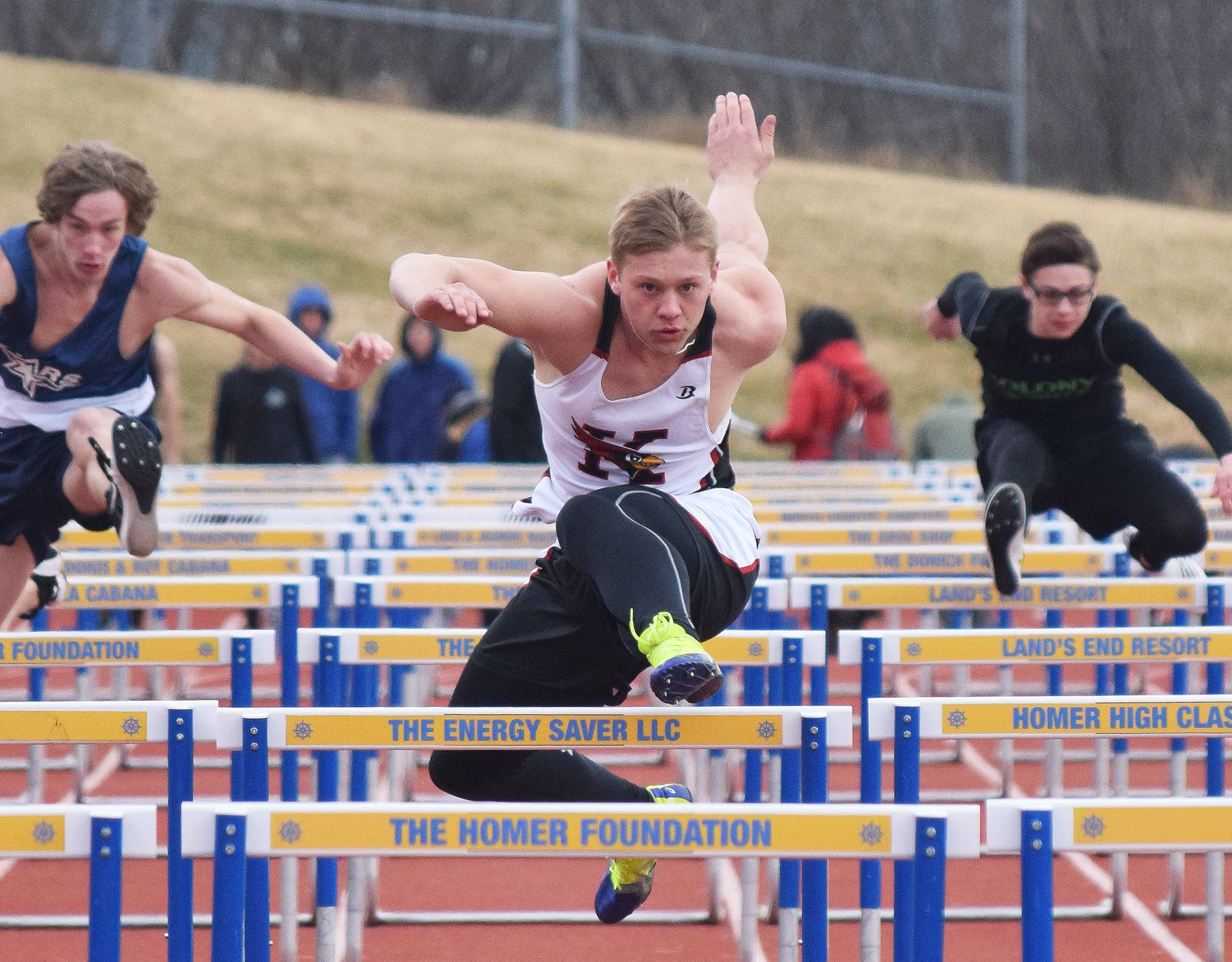 Kenai Central junior Jarett Wilson eyes the finish of the boys 110-meter hurdles Saturday, April 21, 2018, at Homer High School. (Photo by Joey Klecka/Peninsula Clarion)