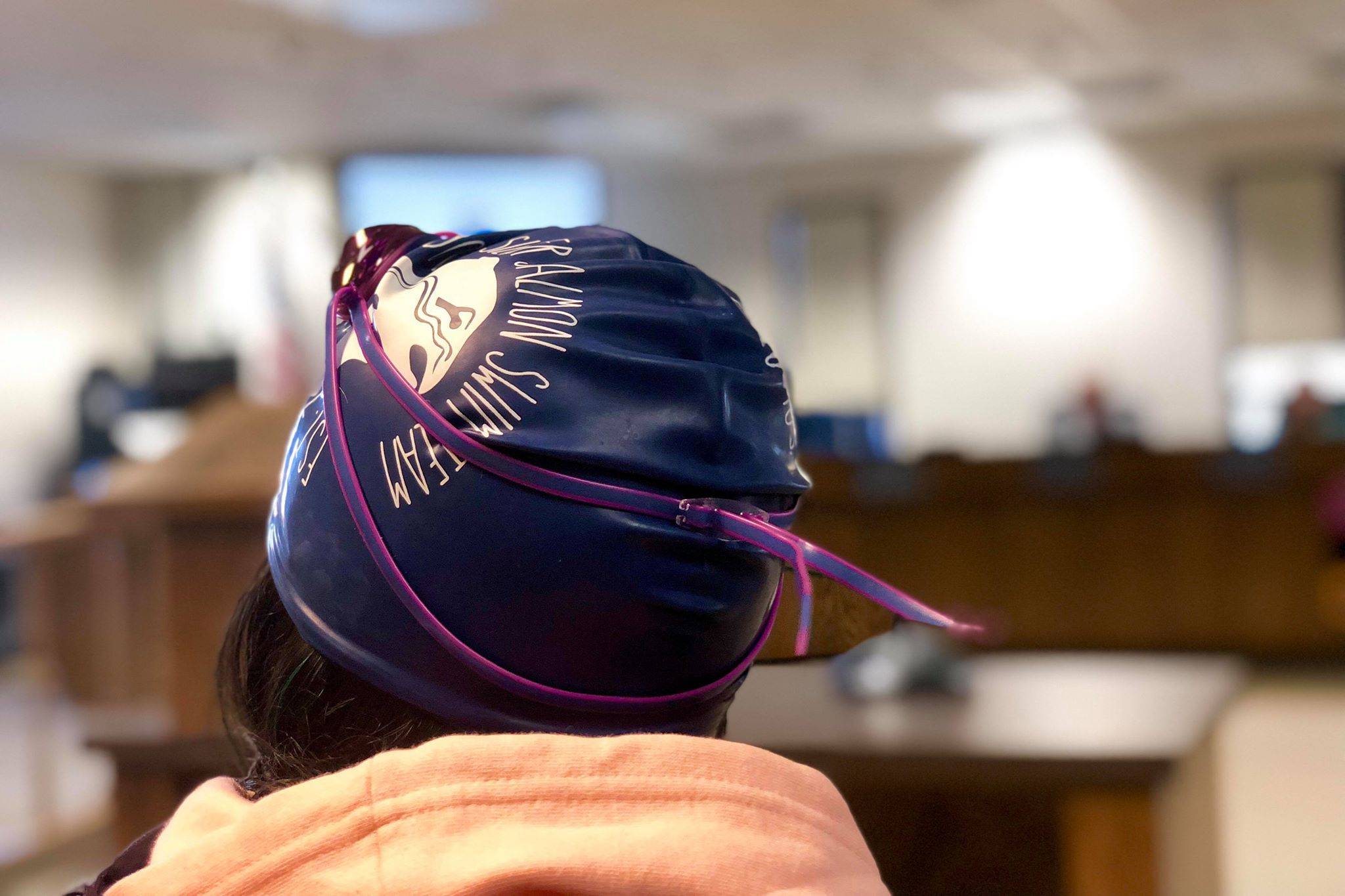 A Soldotna Silver Salmon Swim Team member listens to testimony in support of keeping the Kenai Peninsula Borough School District’s pools open, in light of potential budget cuts, on Monday, April 1, 2019, in Soldotna, Alaska. (Photo by Victoria Petersen/Peninsula Clarion)
