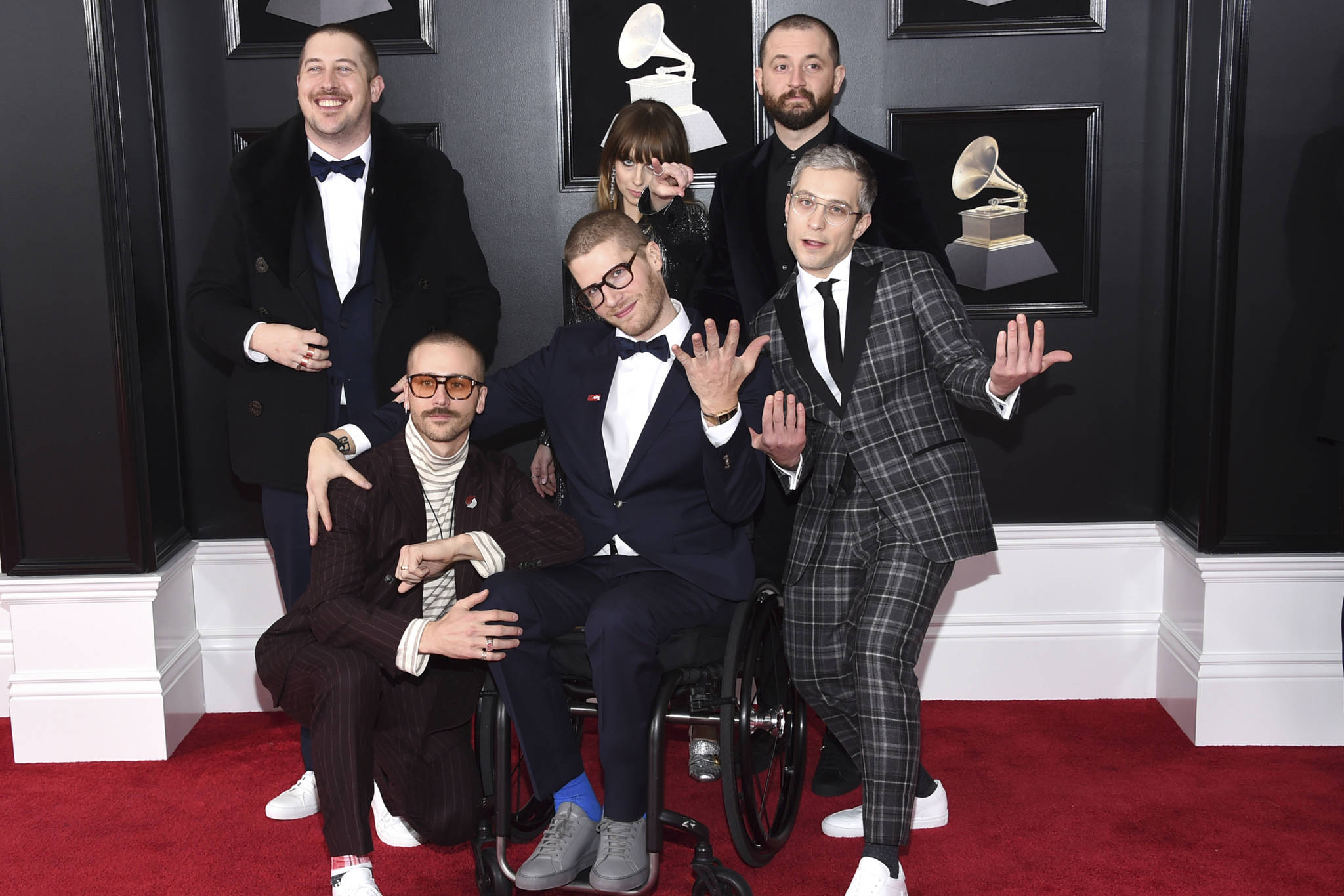 In this Jan. 28, 2018 file photo, from left, Zachary Scott Carothers, John Gourley, Eric Howk, Zoe Manville, Jason Wade Sechrist and Kyle O’Quin of Portugal. The Man arrive at the 60th annual Grammy Awards at Madison Square Garden in New York. The state of Alaska’s new hold music is on hold. A project to replace the sleepy hold music for state office lines with music by Alaska artists drew widespread attention when it was announced in November, touting Portugal. The Man and four other artists with Alaska ties. A spokesman for Gov. Mike Dunleavy says it was muted shortly thereafter after concerns with some of the music were raised by the public.(Photo by Evan Agostini/Invision/AP, File)